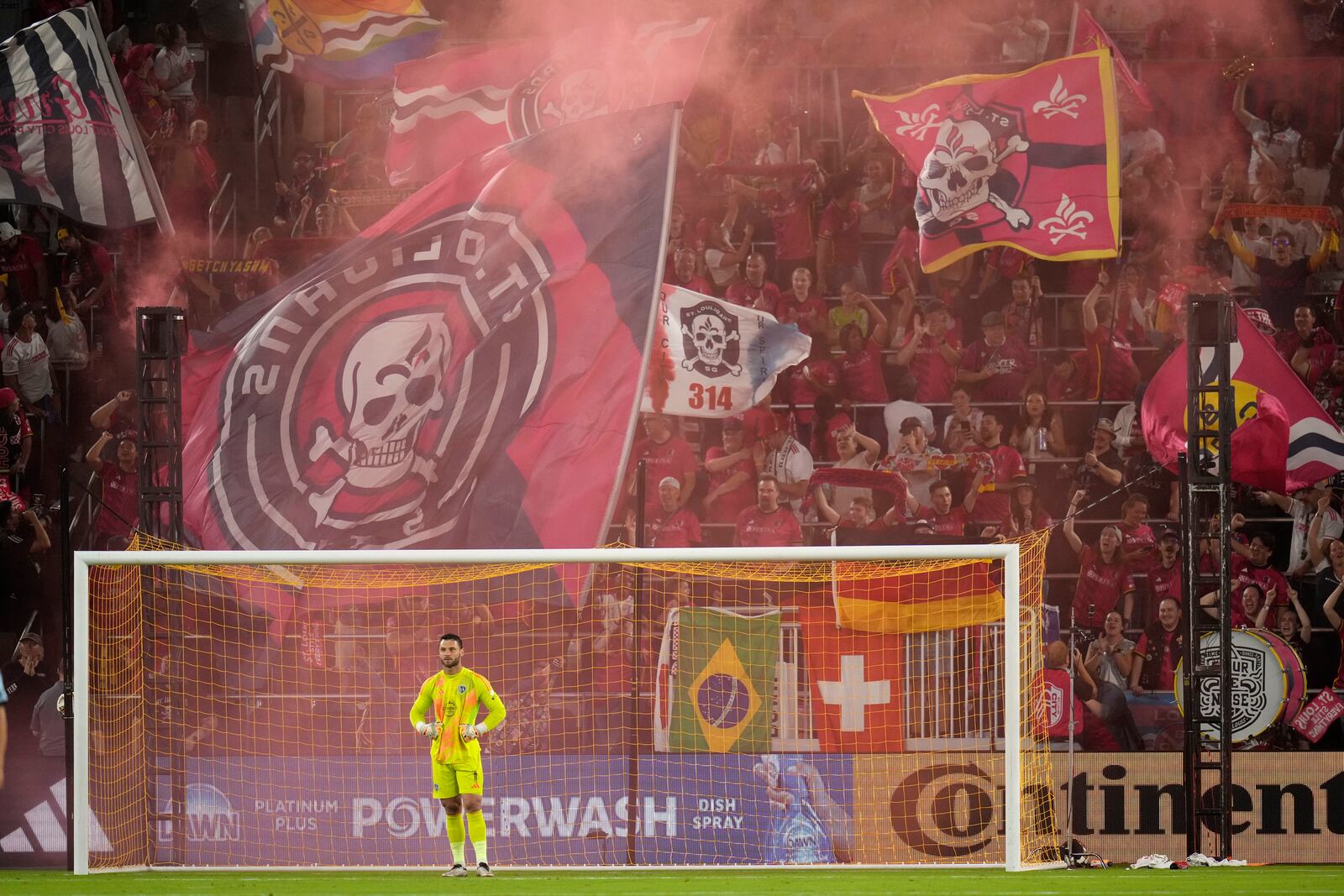 St. Louis City fans celebrate a goal by Cedric Teuchert as Sporting Kansas City goalkeeper John Pulskamp pauses during the first half of an MLS soccer match Saturday, Sept. 28, 2024, in St. Louis. (AP Photo/Jeff Roberson)