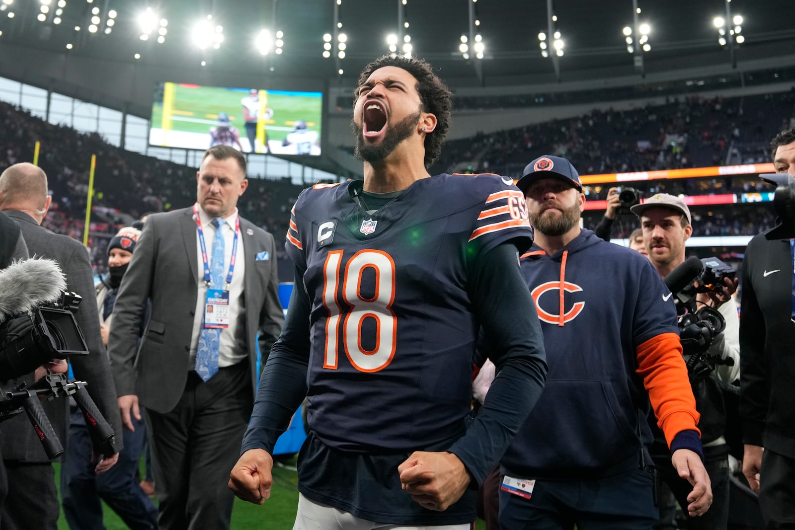 Chicago Bears quarterback Caleb Williams (18) reacts as he leaves the field after an NFL football game at the Tottenham Hotspur stadium between the Jacksonville Jaguars and Chicago Bears in London, Sunday, Oct. 13, 2024. (AP Photo/Alastair Grant)