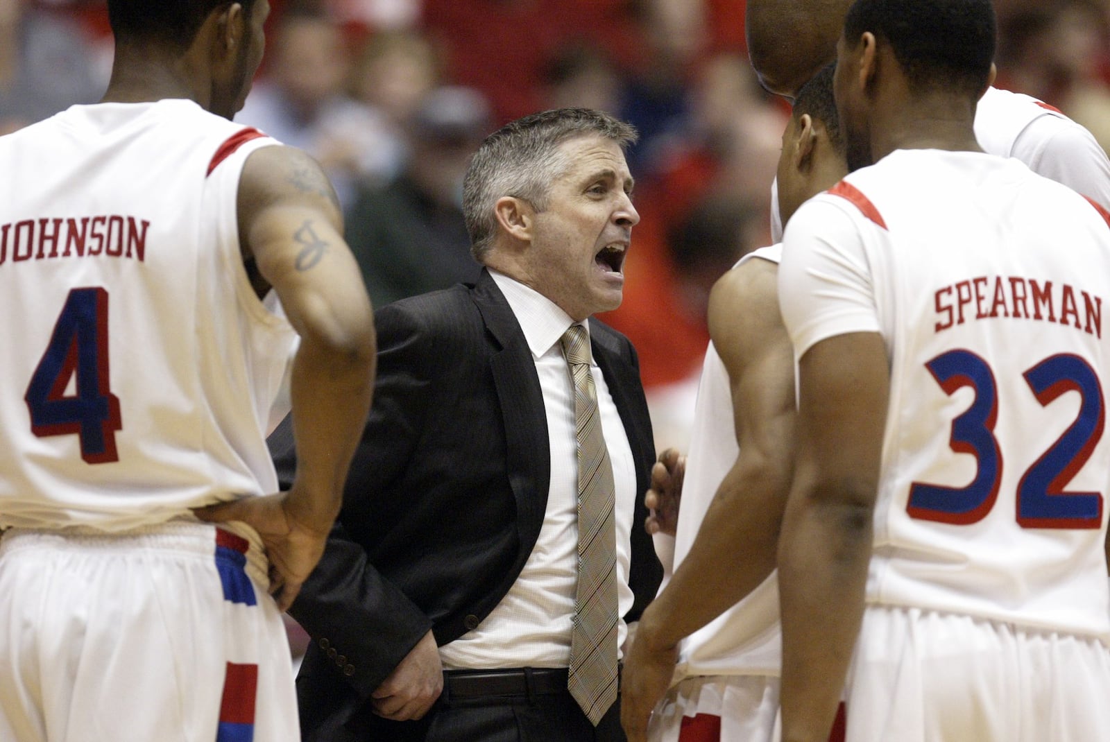 Brian Gregory talks to the Flyers during a second-half timeout against Xavier on Sunday, Feb. 27, at UD Arena.