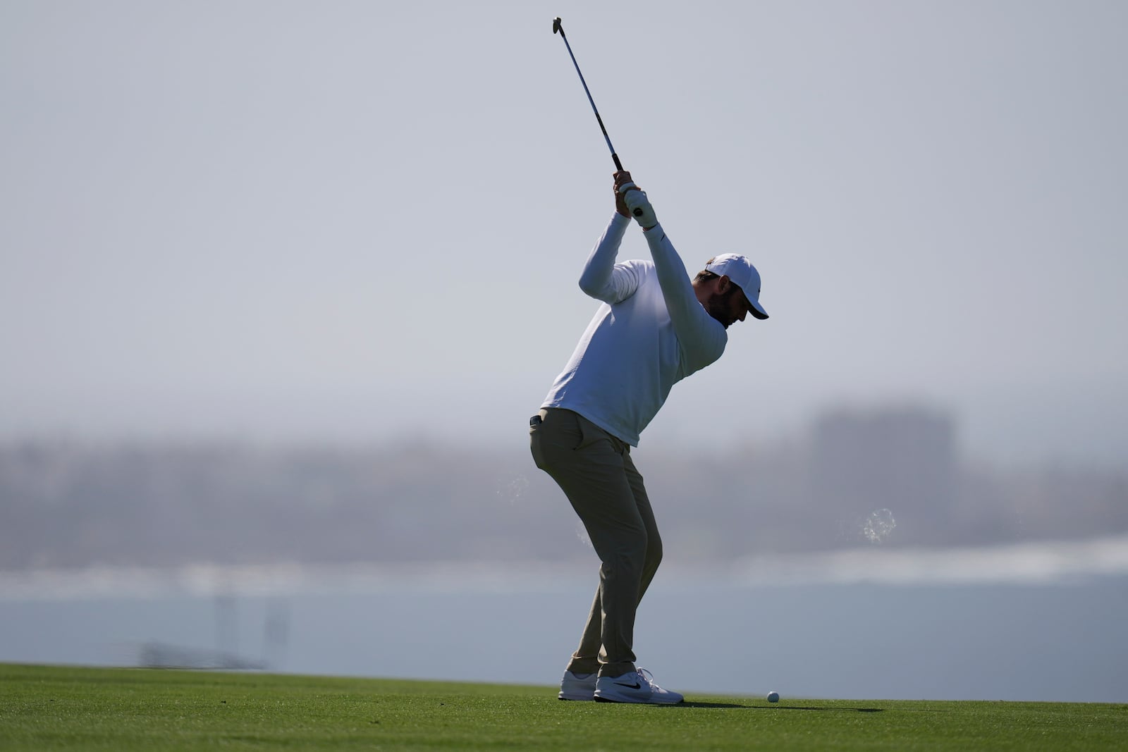 Scottie Scheffler hits on the second fairway of the South Course at Torrey Pines during the third round of the Genesis Invitational golf tournament Saturday, Feb. 15, 2025, in San Diego. (AP Photo/Gregory Bull)