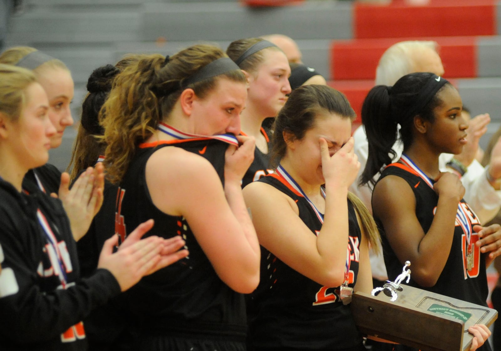 Lexi Moore (middle left) and Cori Dilsavor take a hard loss. MARC PENDLETON / STAFF