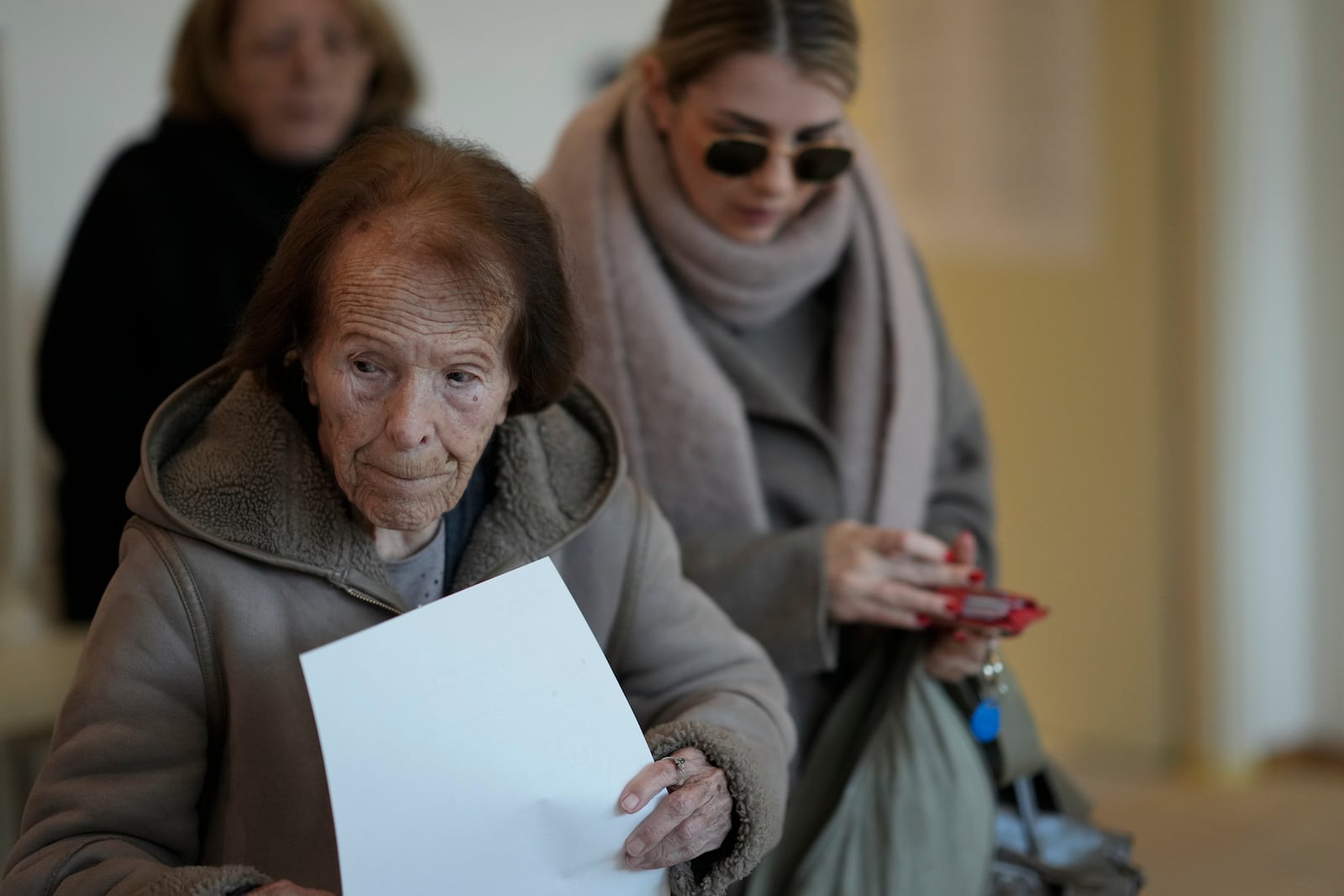 A woman prepares her ballot during a presidential election at a polling station in Zagreb, Croatia, Sunday, Dec. 29, 2024. (AP Photo/Darko Bandic)