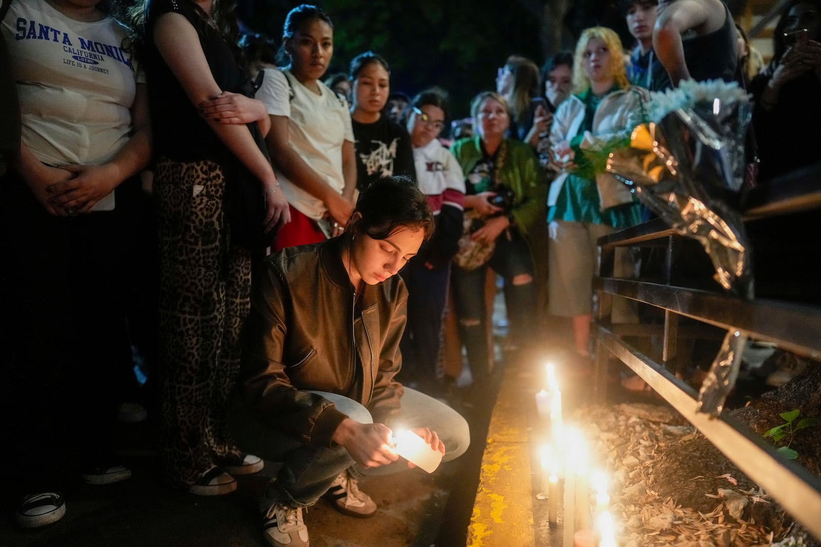 Fans light candles outside the hotel where former One Direction singer Liam Payne was found dead after he fell from a balcony in Buenos Aires, Argentina, Wednesday, Oct. 16, 2024. (AP Photo/Natacha Pisarenko)