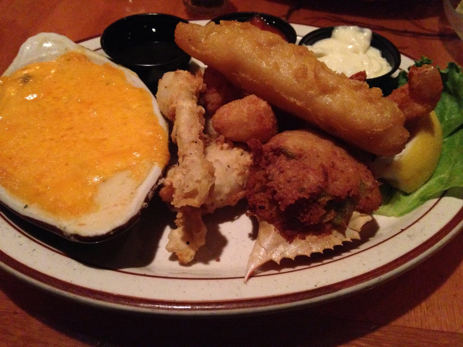 Treasure Island Supper Club's Seafood Platter includes a deviled crab in the shell, two fried shrimp, two frog legs, three fried scaloops and one piece of cod. FILE