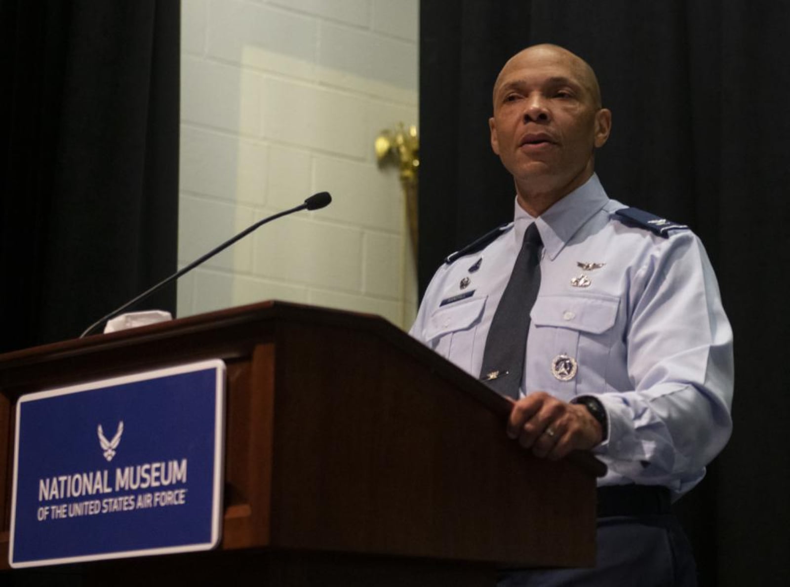 Col. Marqus Randall, National Space Intelligence Center commander, speaks during an interservice transfer ceremony Dec. 16, 2022, at the National Museum of the U.S. Air Force, Wright-Patterson Air Force Base. In the ceremony, 11 former Army Soldiers and 125 former Air Force civilian employees were sworn into the Space Force. (U.S. Air Force photo by R.J. Oriez)