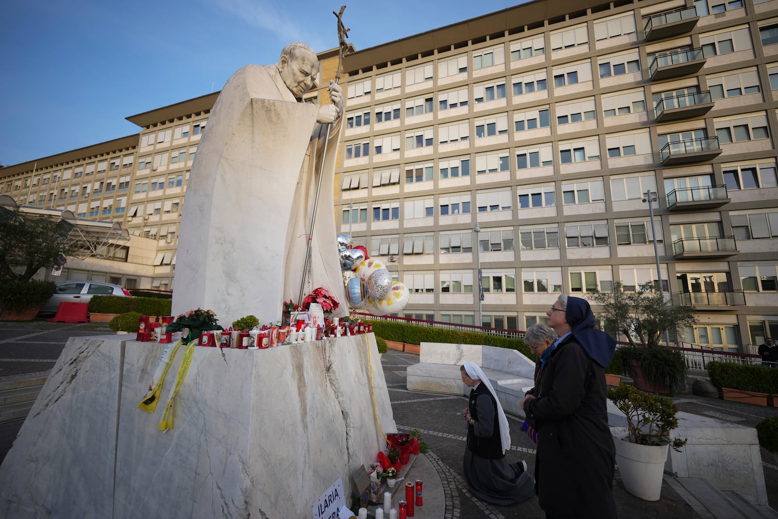 Nuns pray for Pope Francis in front of the Agostino Gemelli Polyclinic, in Rome, Sunday, Feb. 23, 2025, where the Pontiff has been hospitalized since Friday, Feb. 14. (AP Photo/Andrew Medichini)