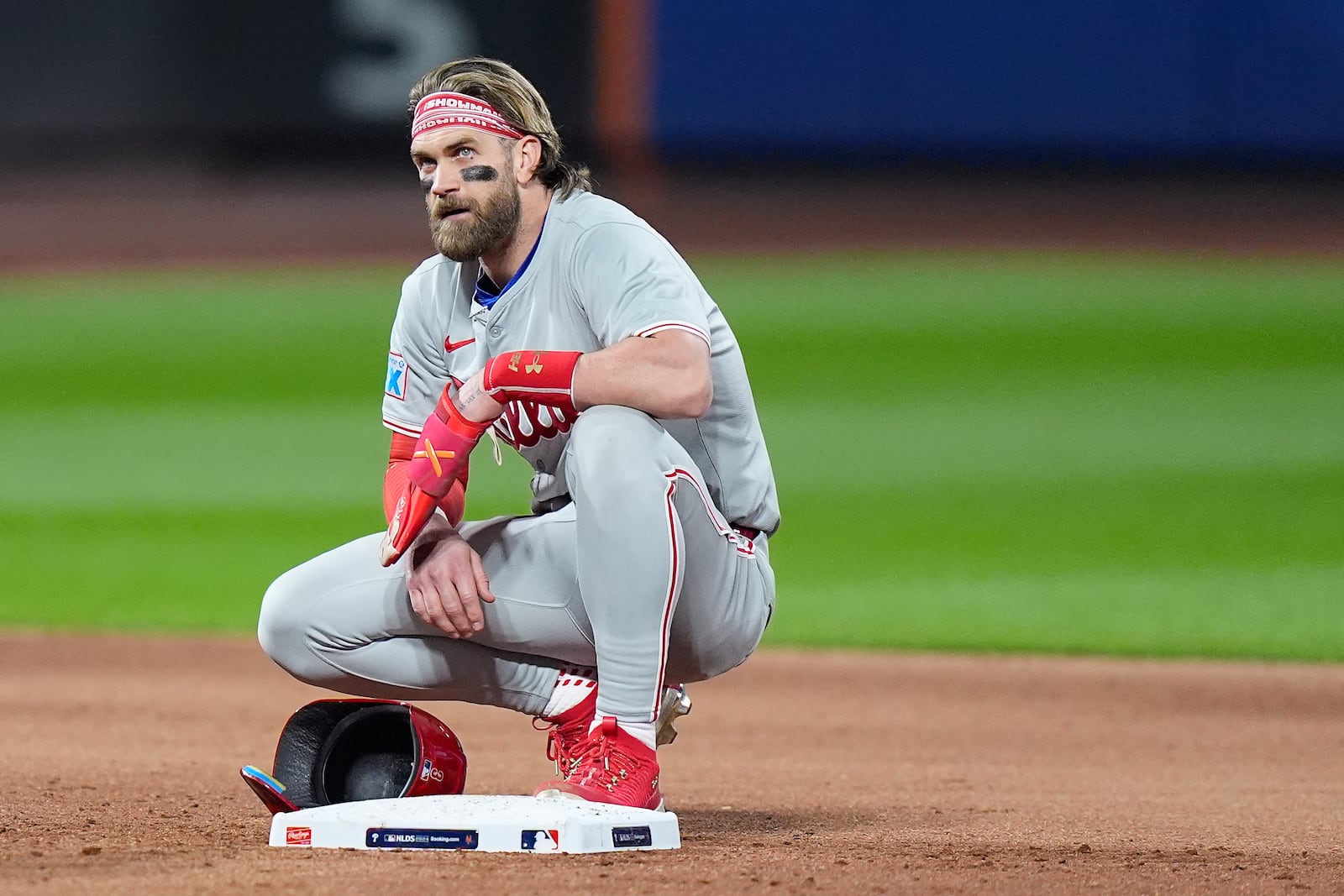 Philadelphia Phillies first baseman Bryce Harper (3) takes a break during a pitching change by the New York Mets during the sixth inning of Game 4 of the National League baseball playoff series, Wednesday, Oct. 9, 2024, in New York. (AP Photo/Frank Franklin II)