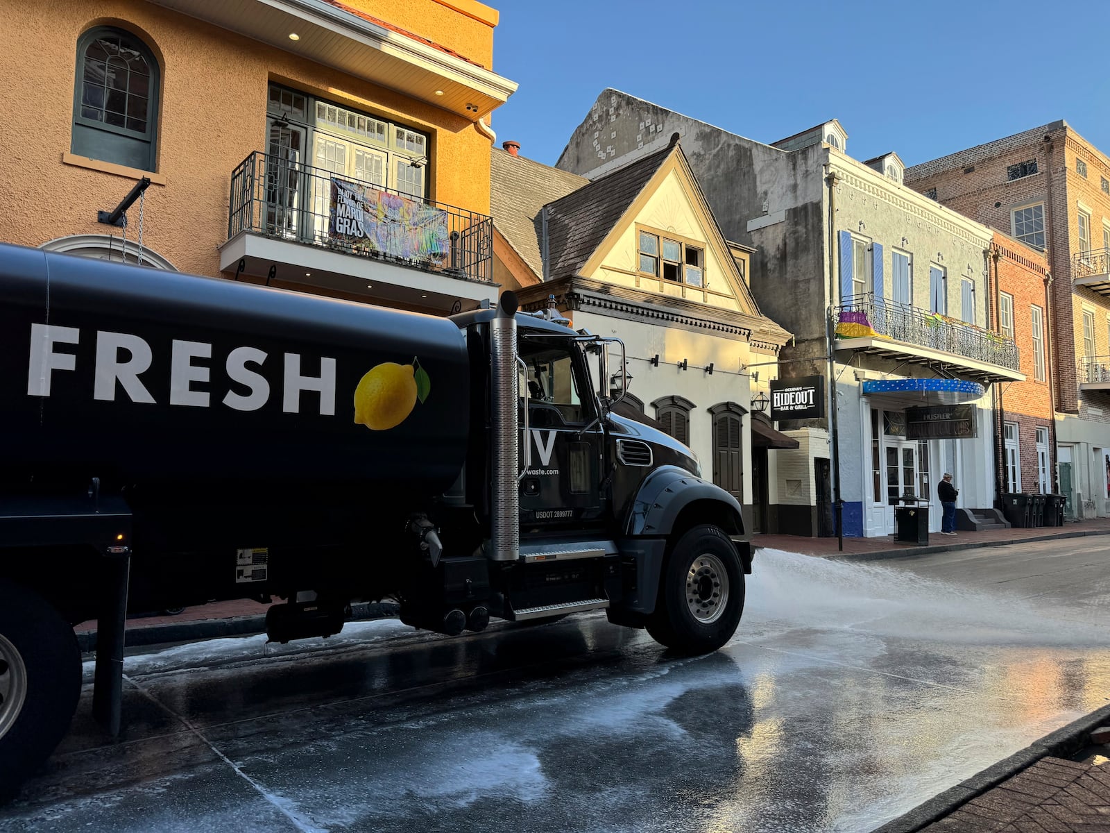 A water truck spraying lemon fragrance washes down Bourbon Street in New Orleans, the day after Mardi Gras, Wednesday, March 5, 2025. (AP Photo/Jack Brook)