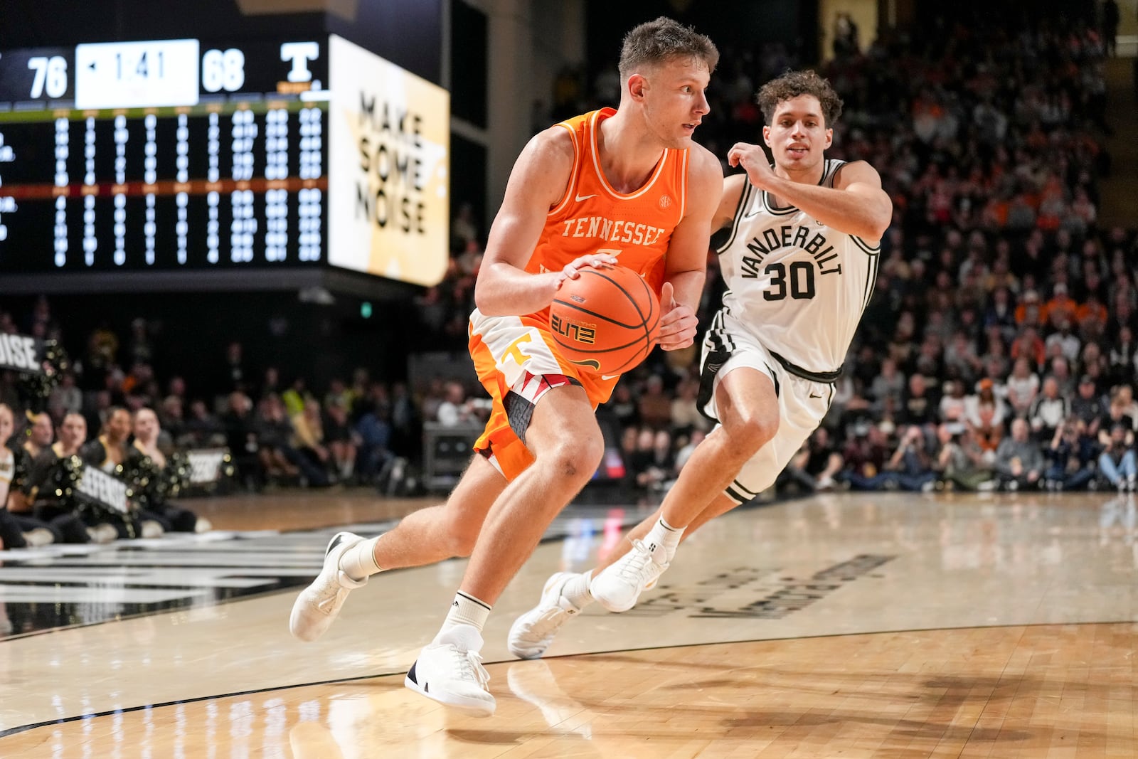 Tennessee forward Igor Milicic Jr. (7) dribbles the ball past Vanderbilt guard Chris Manon (30) during the second half of an NCAA college basketball game Saturday, Jan. 18, 2025, in Nashville, Tenn. (AP Photo/George Walker IV)