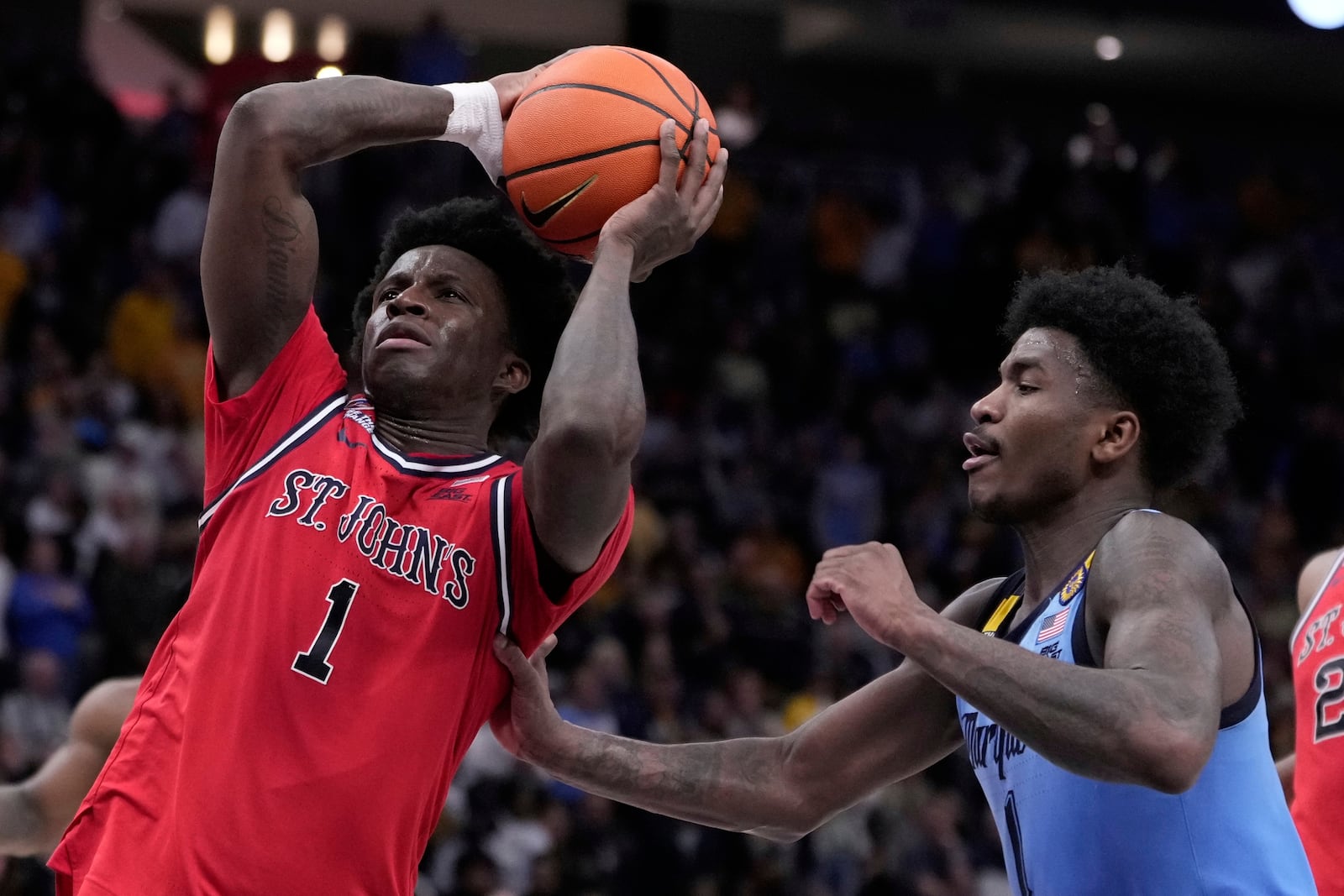 St. John's's Kadary Richmond gets past Marquette's Kam Jones during the second half of an NCAA college basketball game Saturday, March 8, 2025, in Milwaukee. (AP Photo/Morry Gash)