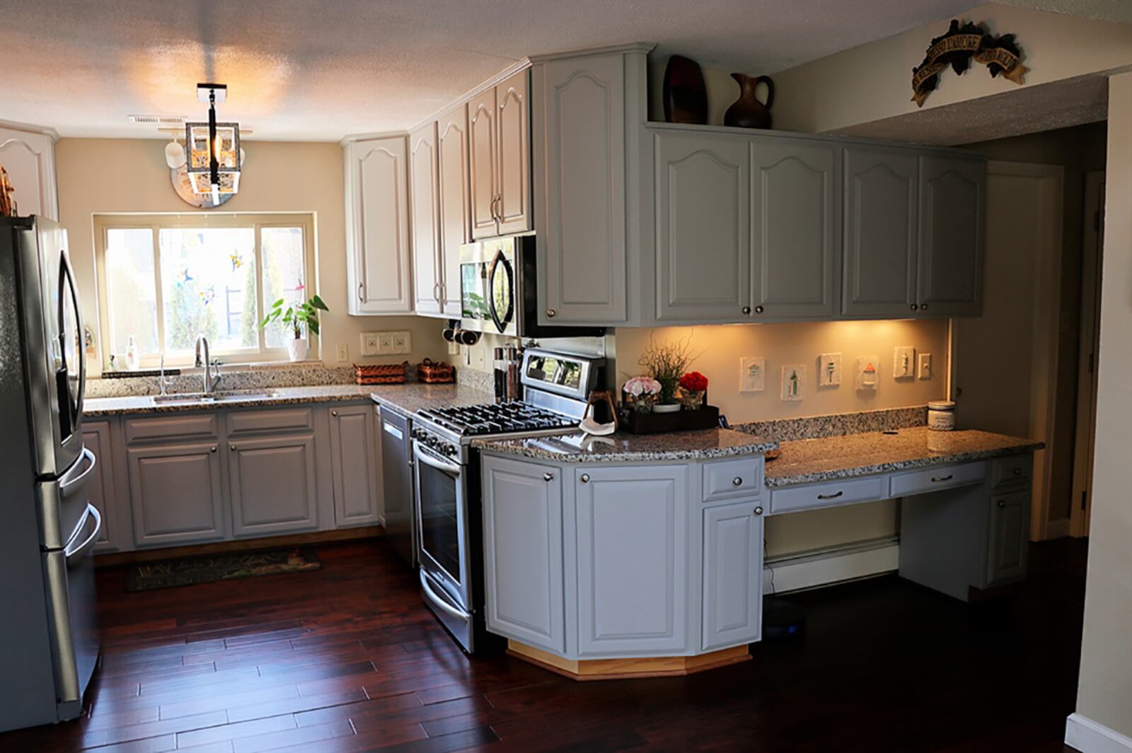 The updated kitchen has a picture window above the double sink, and an abundance of cabinetry wraps around the wall space, creating plenty of countertop work space surrounding the stainless-steel appliances. CONTRIBUTED PHOTO BY KATHY TYLER