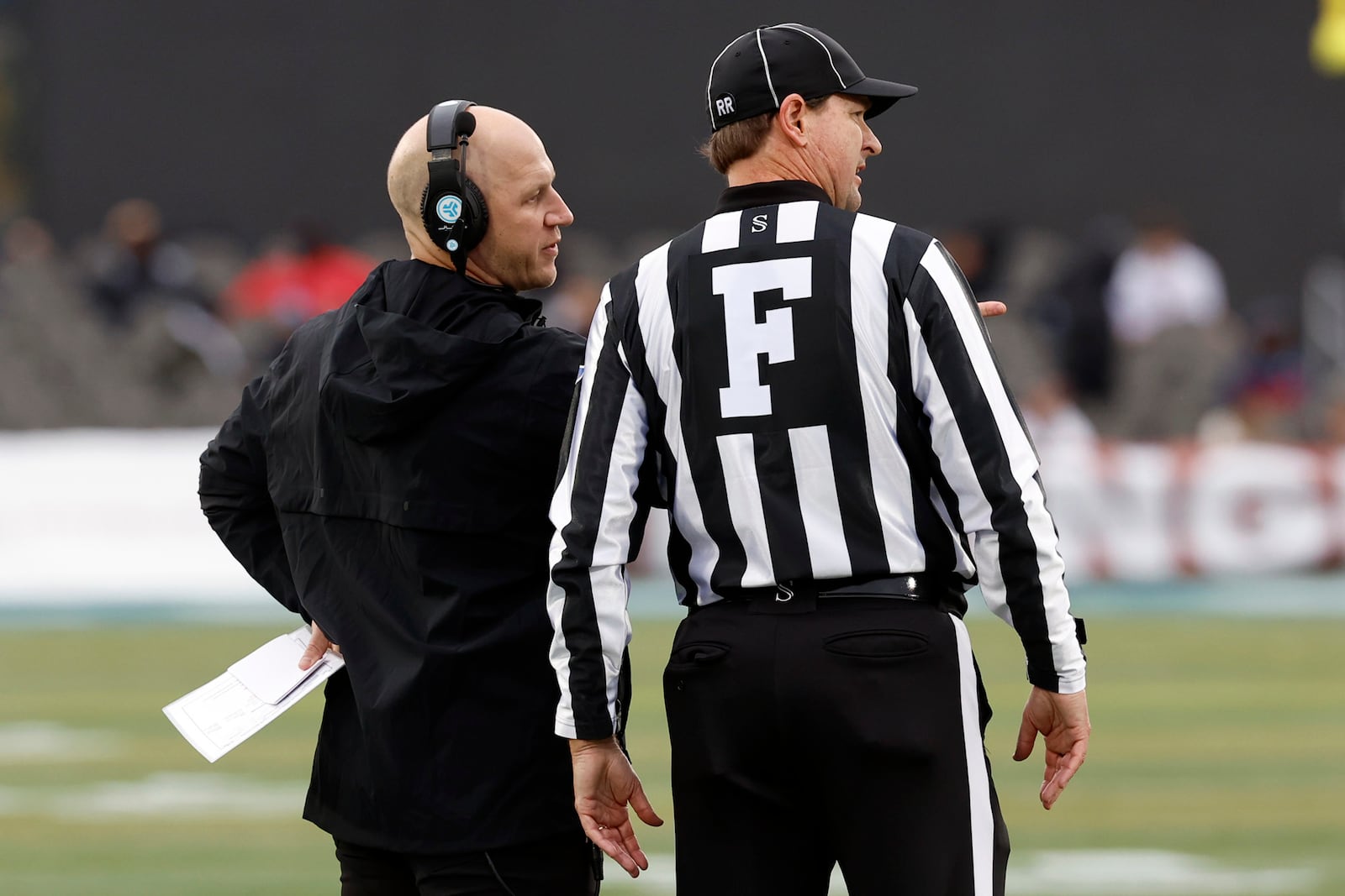 Vanderbilt head coach Clark Lea, left, talks with a referee, right, after a play during the first half of the Birmingham Bowl NCAA college football game against Georgia Tech, Friday, Dec. 27, 2024, in Birmingham, Ala. (AP Photo/Butch Dill)