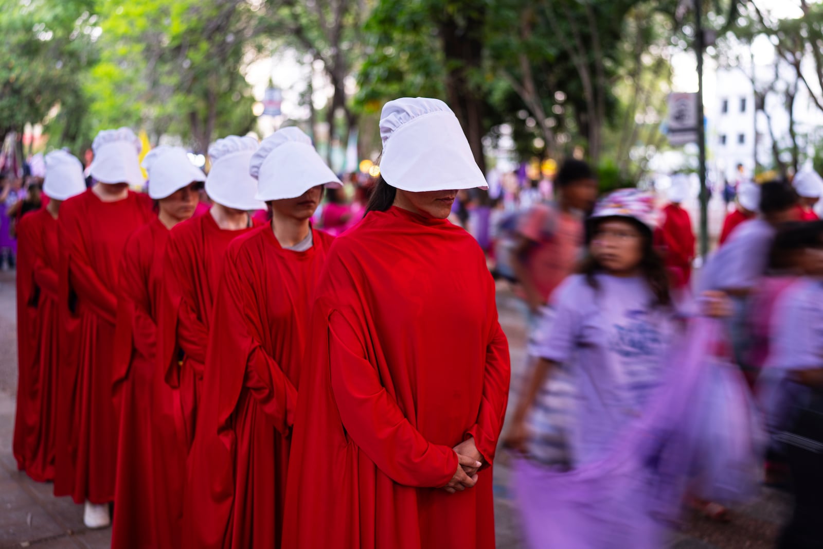 People reenact "The Handmaid's Tale," a novel, during a march marking the International Day for the Elimination of Violence against Women march, in Asuncion, Paraguay, Monday, Nov. 25, 2024. (AP Photo/Jorge Saenz)