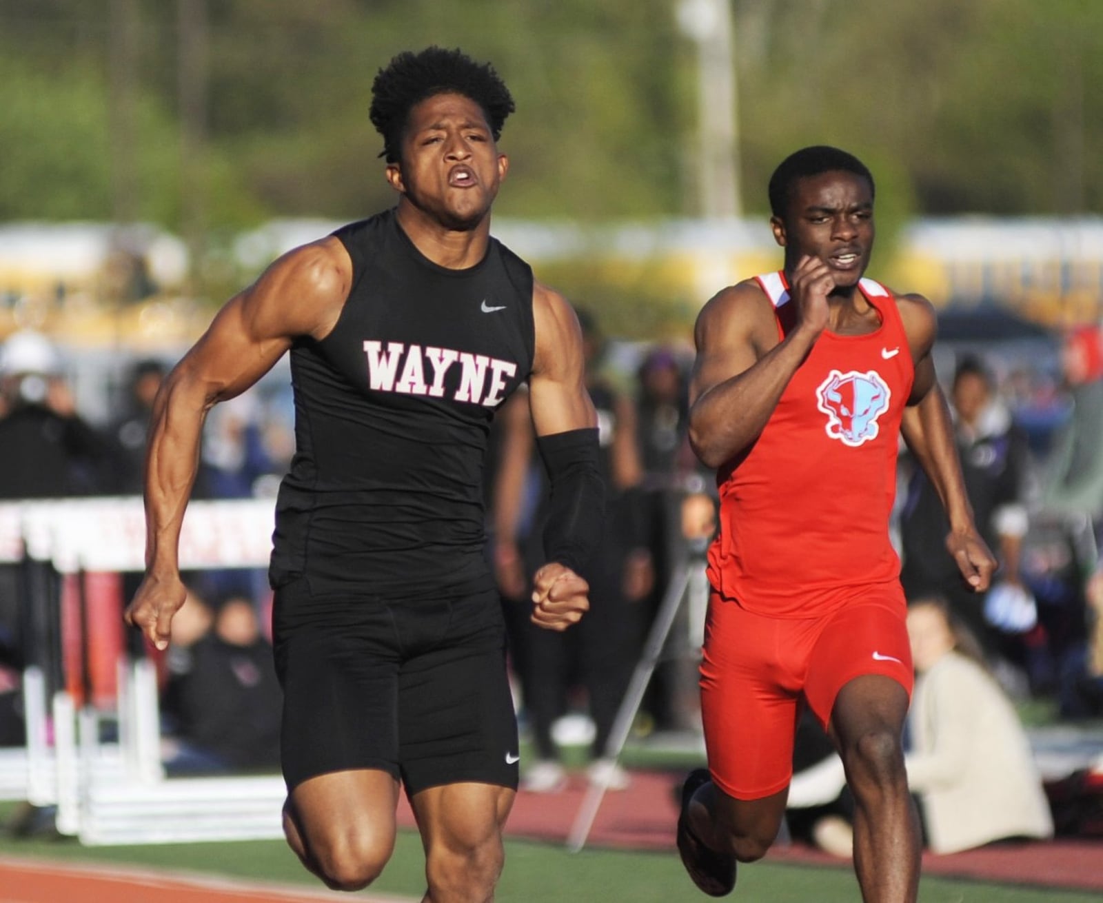 Wayne’s Zarik Brown (left) won the 100 meters and Herman Chongwain of Belmont was sixth during the Wayne Inv. on Friday, April 26, 2019. MARC PENDLETON / STAFF