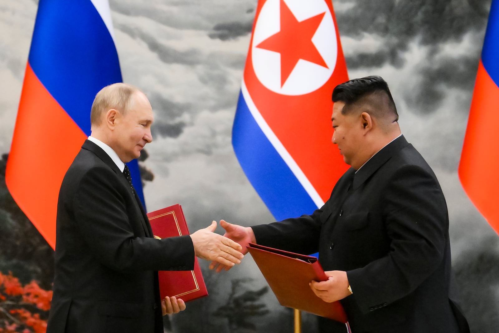 FILE - Russian President Vladimir Putin and North Korean leader Kim Jong Un exchange documents during a signing ceremony of a new partnership in Pyongyang, North Korea, on June 19, 2024. (Kristina Kormilitsyna, Sputnik, Kremlin Pool Photo via AP, File)