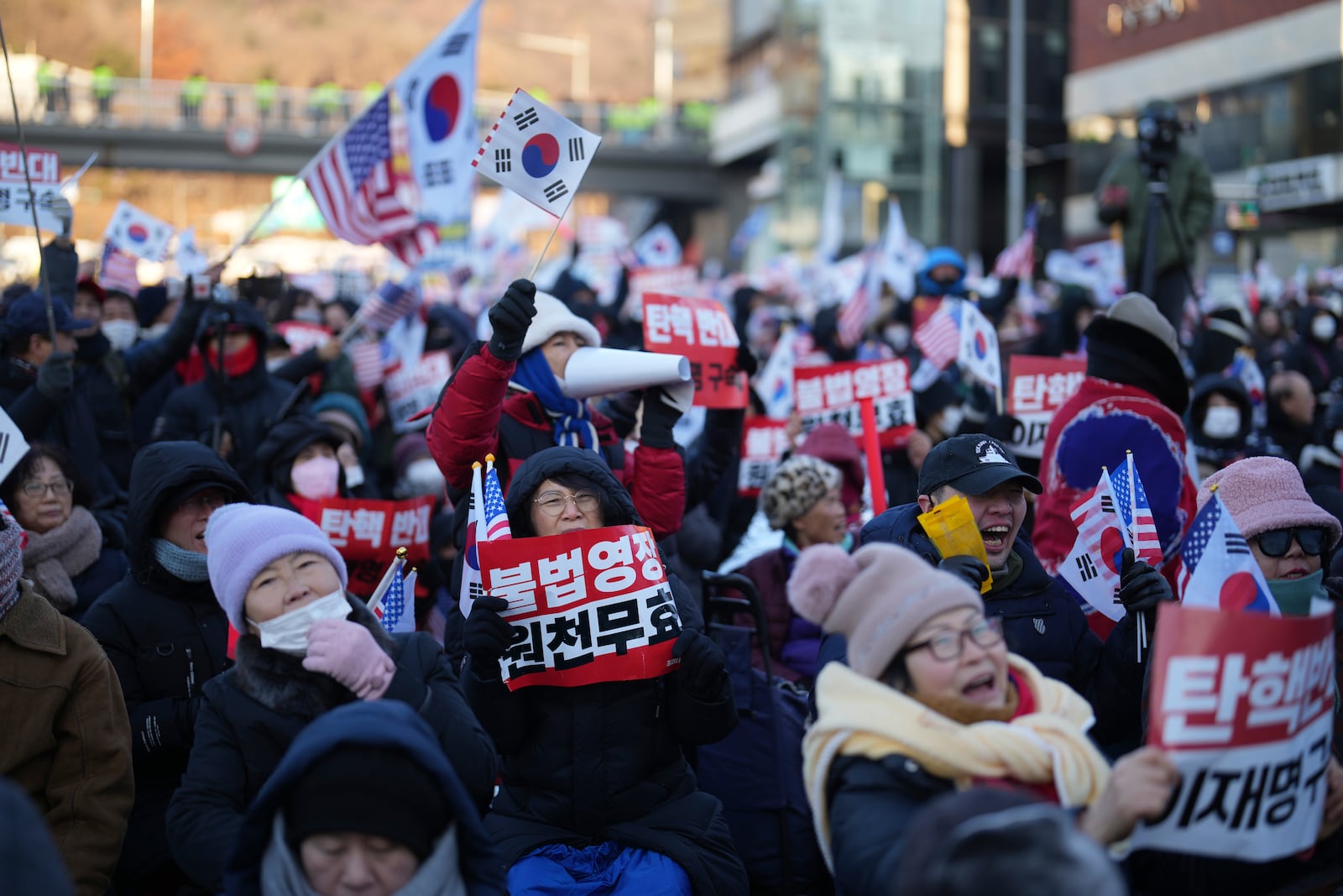 Supporters of impeached South Korean President Yoon Suk Yeol stage a rally to oppose a court having issued a warrant to detain Yoon, near the presidential residence in Seoul, South Korea, Friday, Jan. 3, 2025. The letters read "Oppose Impeachment." (AP Photo/Lee Jin-man)