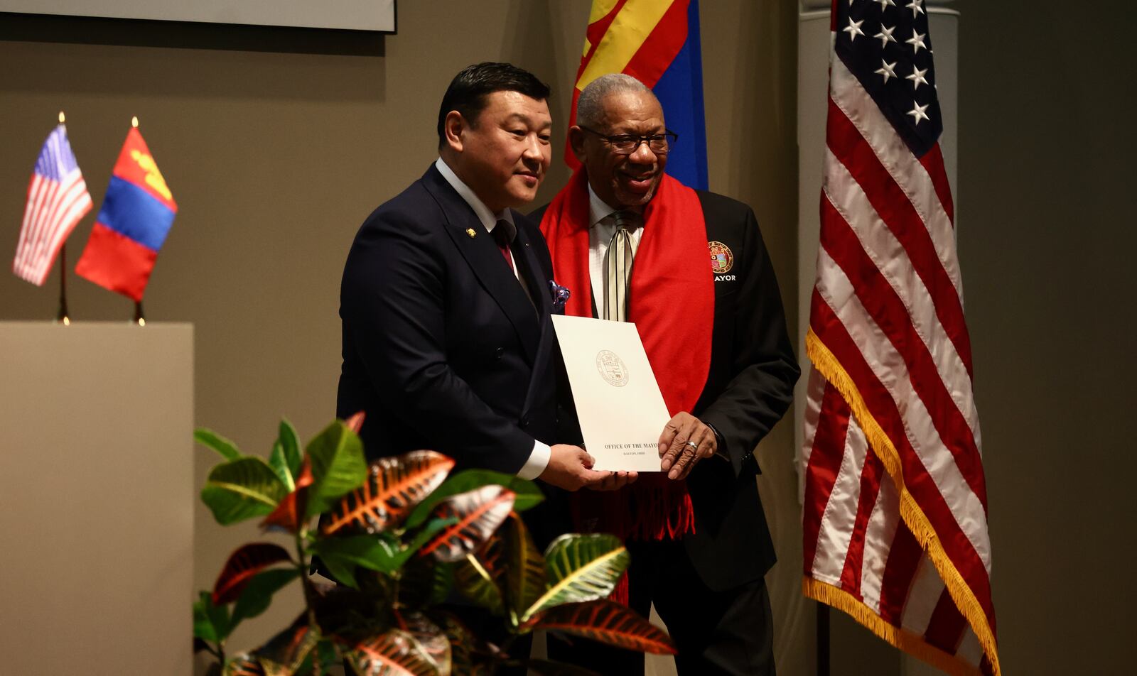 H.E. Batbayar Ulziidelger, Ambassador Extraordinary and Plenipotentiary of Mongolia to the USA, and Dayton Mayor Jeffrey J. Mims Jr., hold proclamations honoring Dayton guard Mike Sharavjamts at a Mongolian Day event in Dayton at the CareSource building in downtown Dayton on Friday, Feb. 10, 2023. David Jablonski/Staff