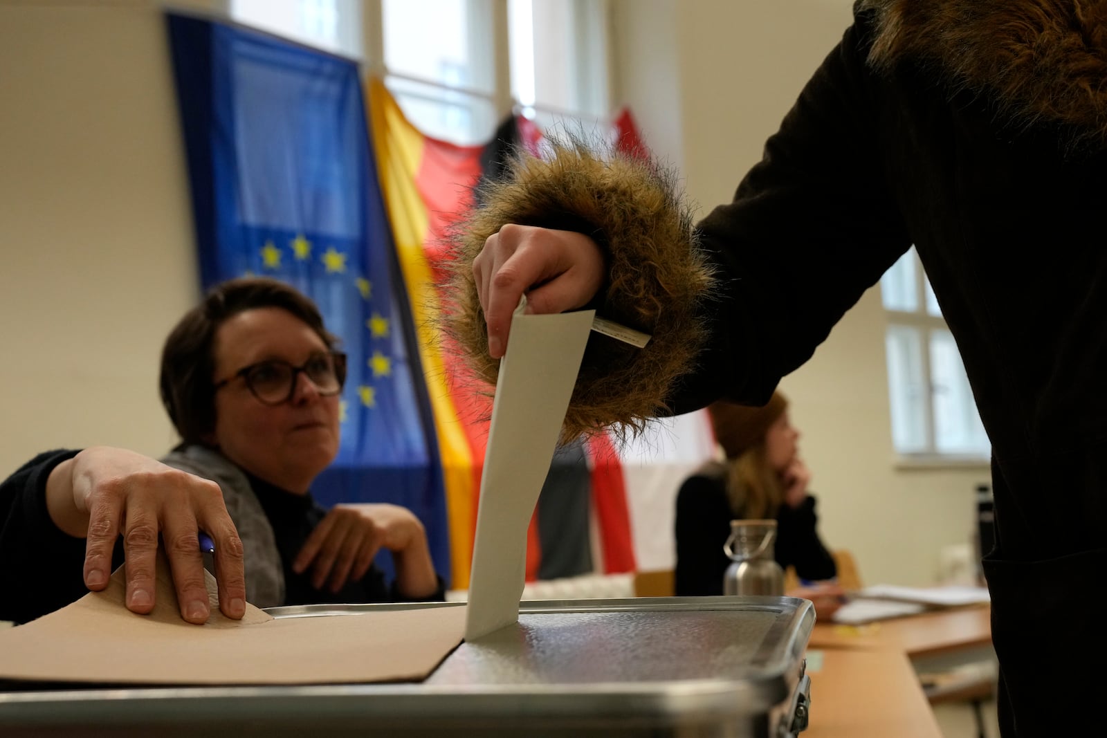 A resident casts a vote at a polling station in Berlin, Germany, Sunday, Feb. 23, 2025, during the German national election. (AP Photo/Czarek Sokolowski)