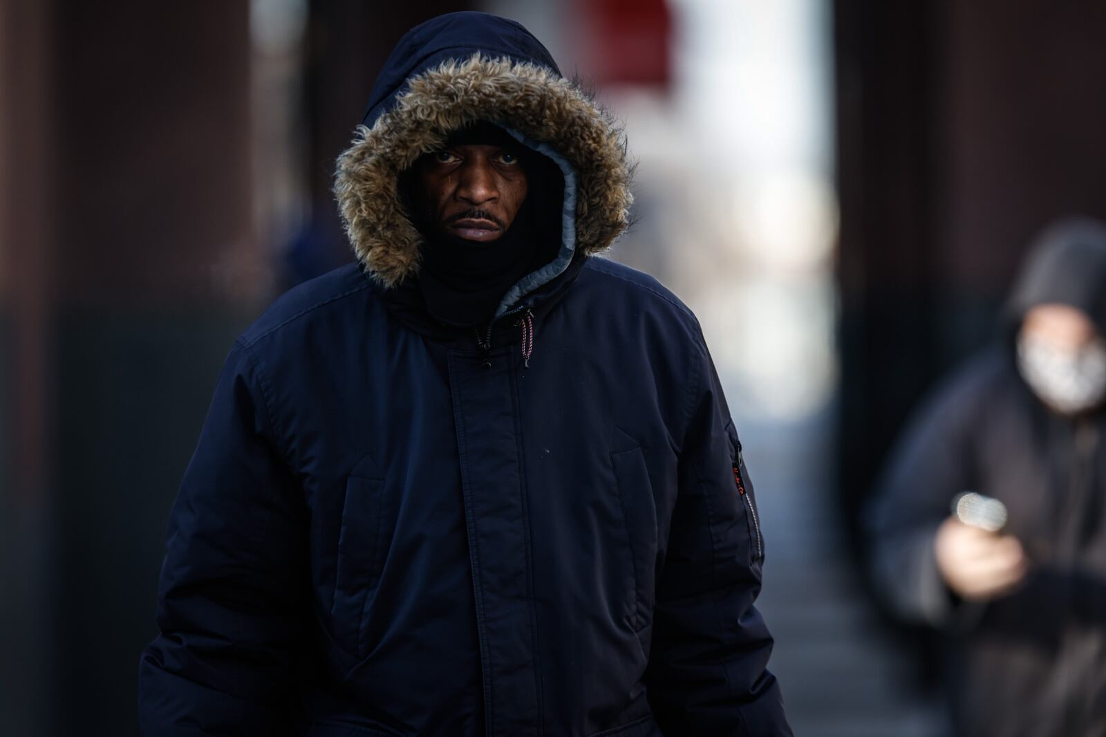 Pedestrians walk in downtown Dayton on a frigid Wednesday morning. Jim Noelker/Staff