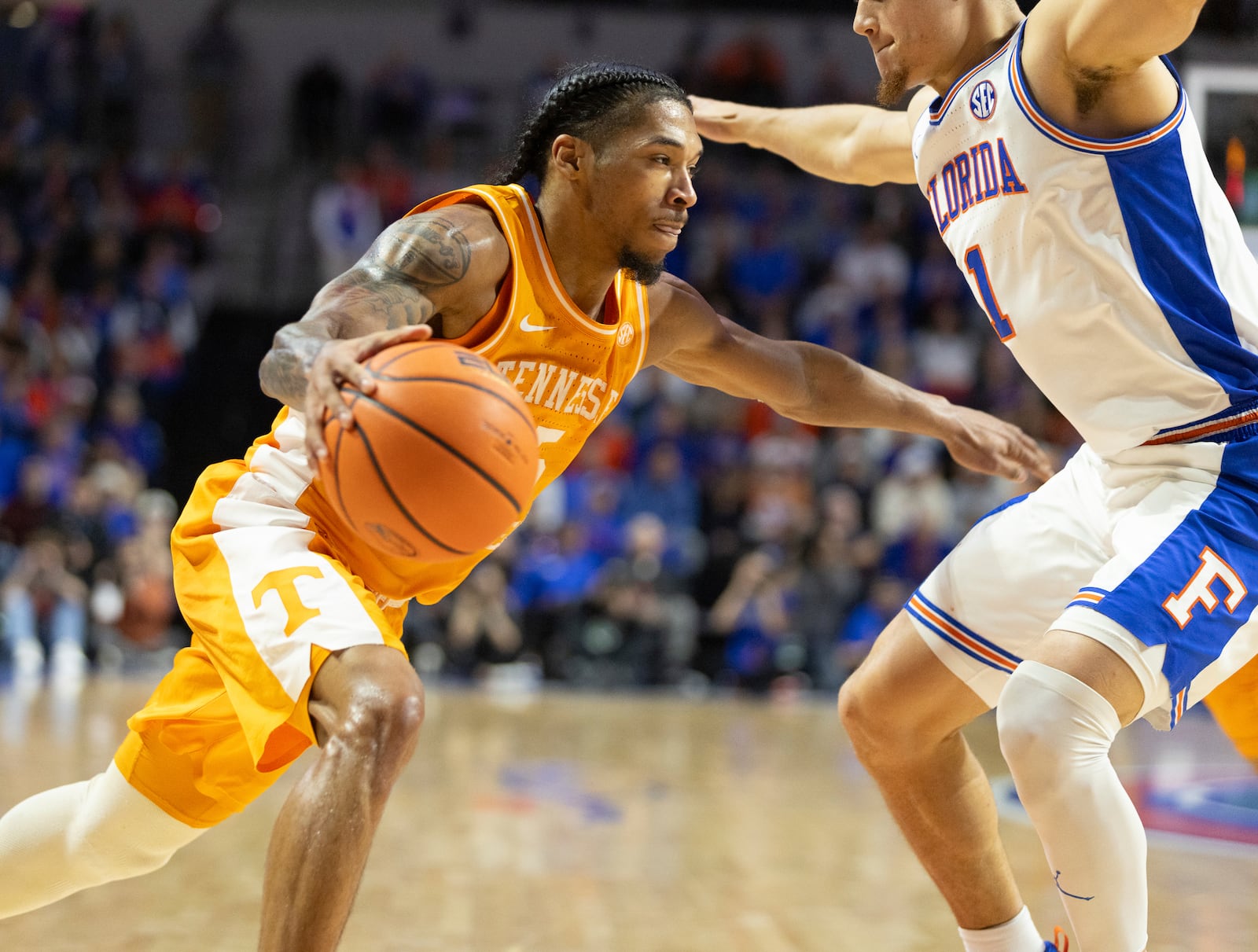 Tennessee guard Zakai Zeigler drives on Florida guard Walter Clayton Jr. (1) during the first half of an NCAA college basketball game, Tuesday, Jan. 7, 2025, in Gainesville, Fla. (AP Photo/Alan Youngblood)