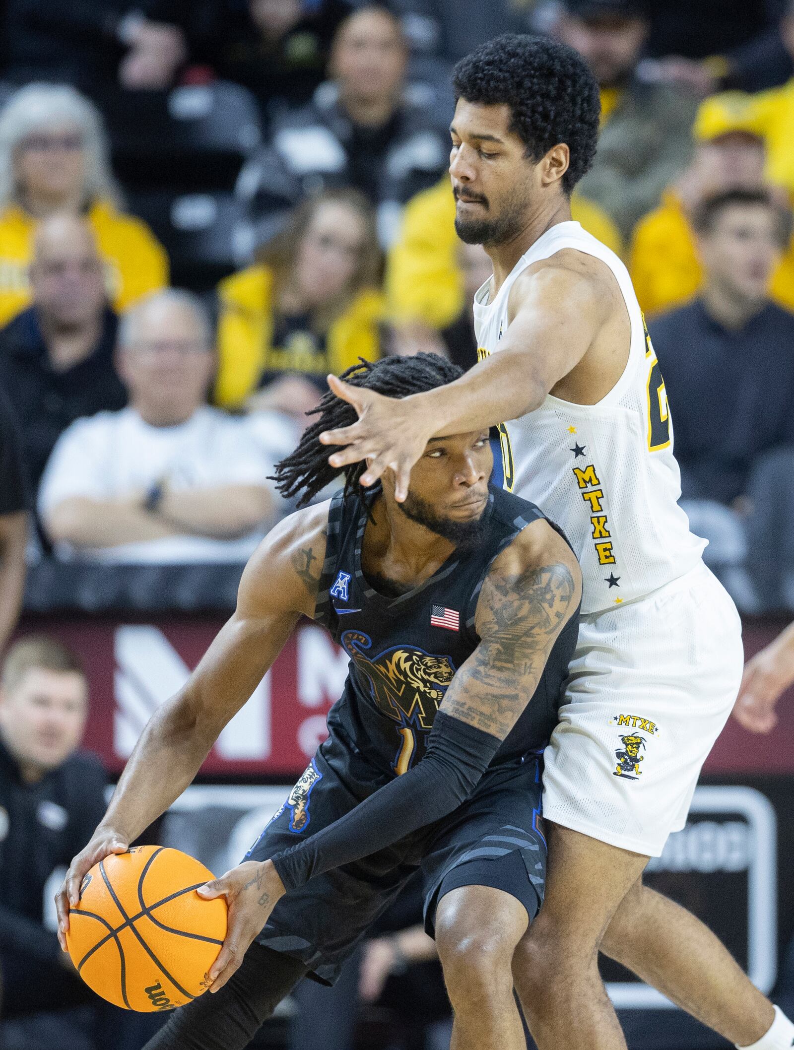 Wichita State's Harlond Beverly, right, defends against Memphis's Tyrese Hunter during the first half of an NCAA college basketball game, Sunday, Feb. 16, 2025, in Wichita, Kan. (AP Photo/Travis Heying)