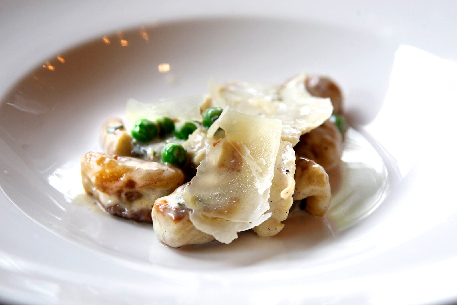 Cooperâs Hawk Winery & Restaurant, located in the Cornerstone of Centerville, opens Monday, Aug. 26. One of the entrees on their menu is gnoccchi carbonara with pancetta, chicken, sage, peas and parmesan garlic cream sauce. LISA POWELL / STAFF