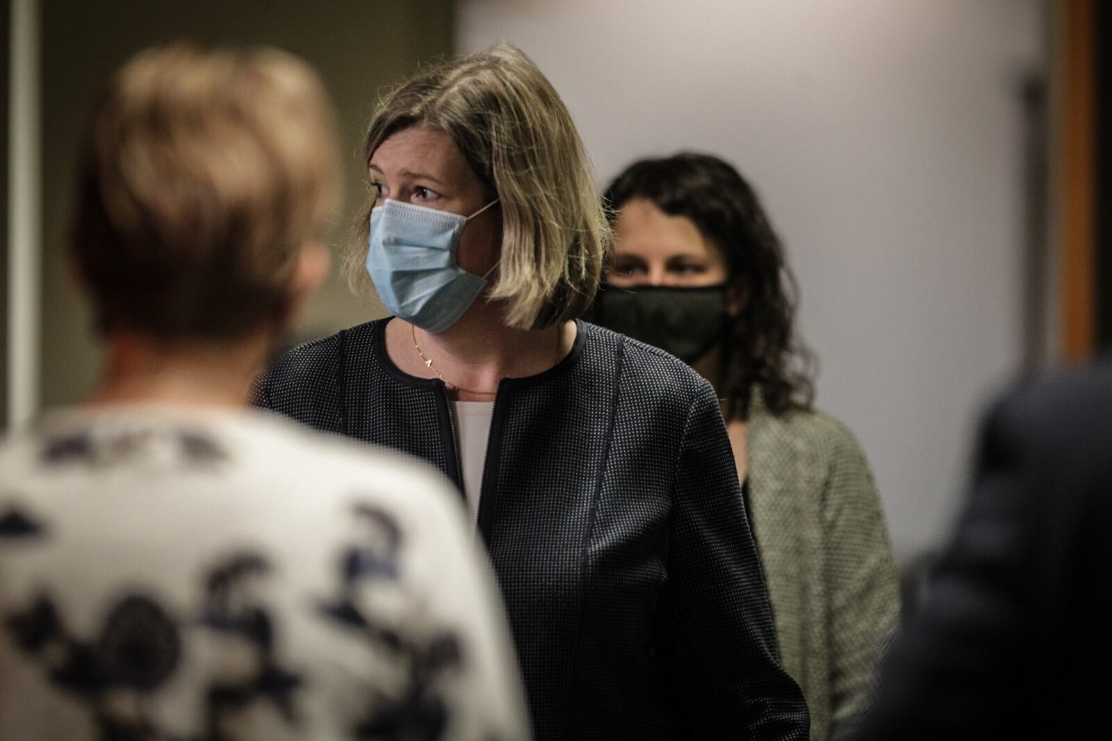 Dayton Mayor Nan Whaley, center, waits for the start of a news conference Oct. 15, 2020, on the uptick in COVID-19 cases locally and in the state. JIM NOELKER/STAFF