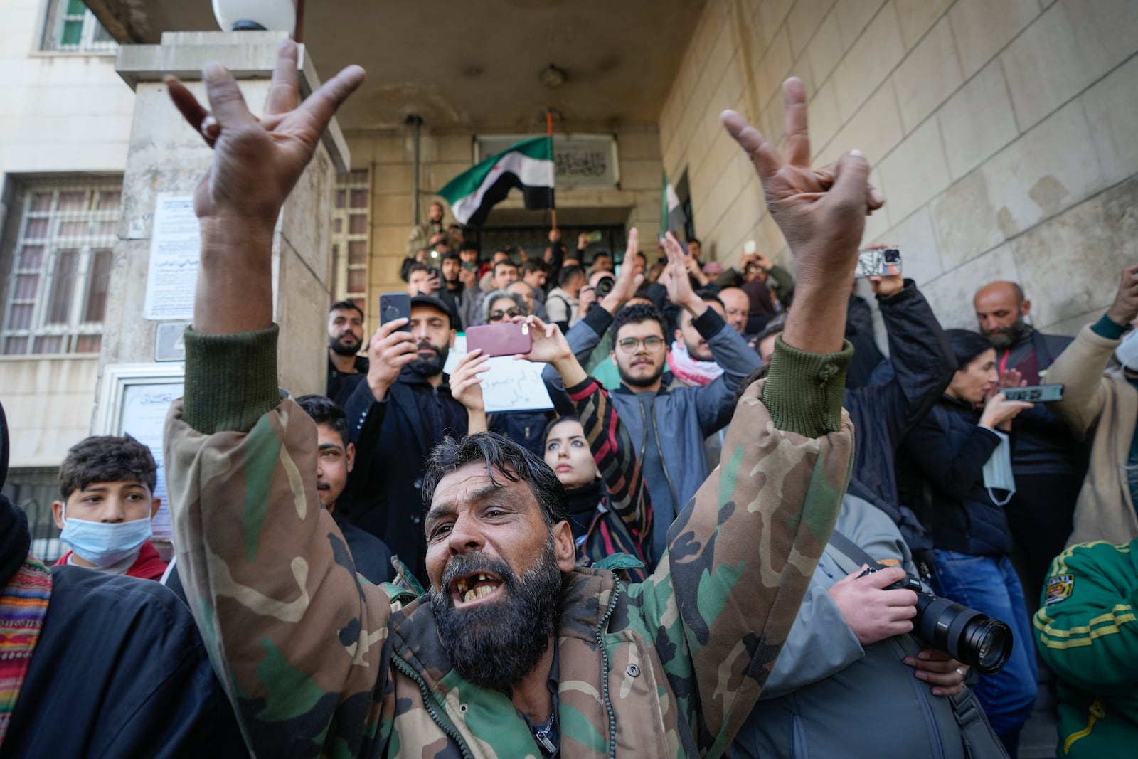 Morners attend the funeral procession of Syrian activist Mazen al-Hamada in Damascus Thursday Dec. 12, 2024. Al-Hamad's mangled corpse was found wrapped in a bloody sheet in Saydnaya prison. He had fled to Europe but returned to Syria in 2020 and was imprisoned upon arrival. (AP Photo/Hussein Malla)