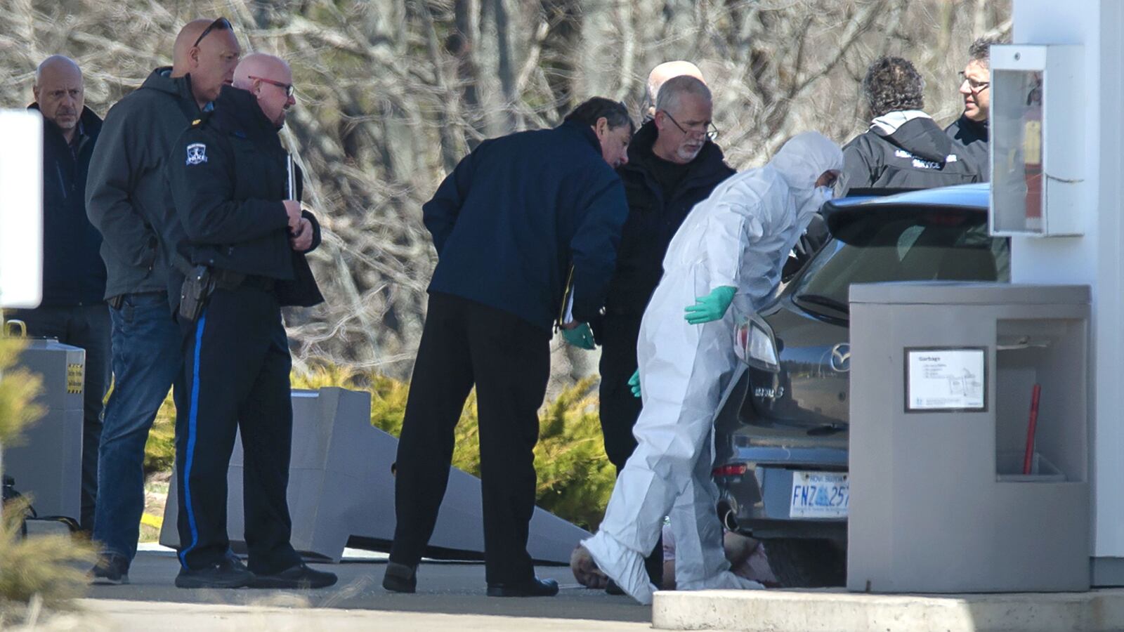 Royal Canadian Mounted Police investigators and crime scene technicians surround a vehicle driven by alleged shooter Gabriel Wortman at a gas station in Enfield, Nova Scotia, Sunday April 19, 2020. A total of 22 people were killed in the deadliest mass shooting in Canada in 30 years. Accused gunman Wortman, 51, was killed in a shootout with police.