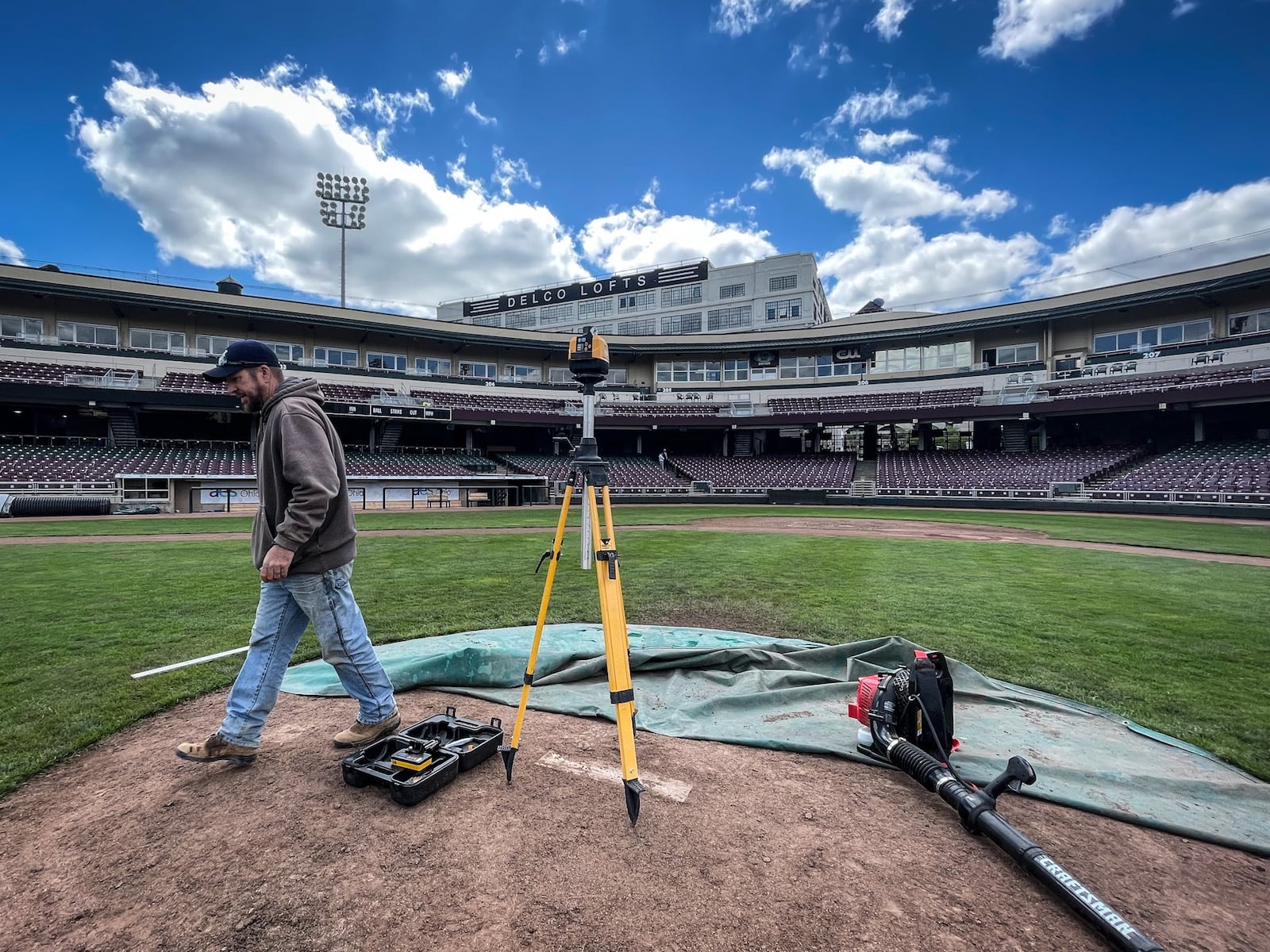 Andy Ross uses a laser to grade Day Air Ballpark Wednesday May 5, 2021. The home opener is Tuesday May 11, 2021. JIM NOELKER/STAFF