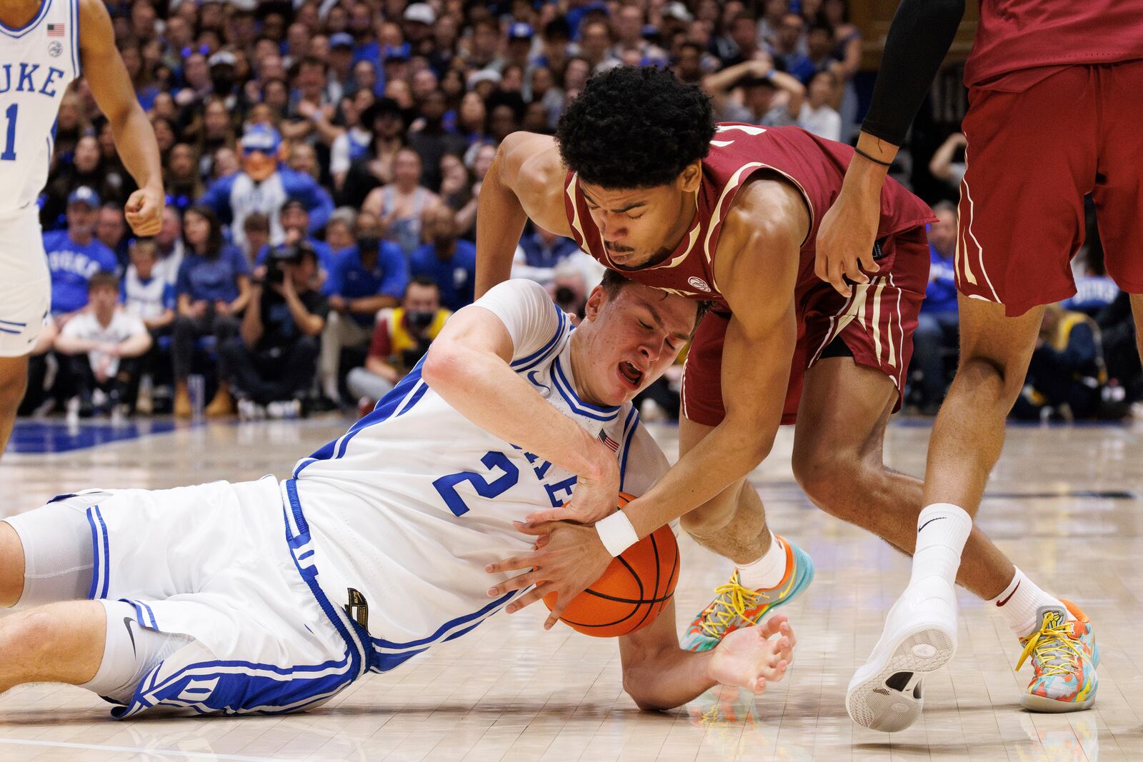 Duke's Cooper Flagg (2) and Florida State's Bostyn Holt, right, battle for the ball during the second half of an NCAA college basketball game in Durham, N.C., Saturday, March 1, 2025. (AP Photo/Ben McKeown)