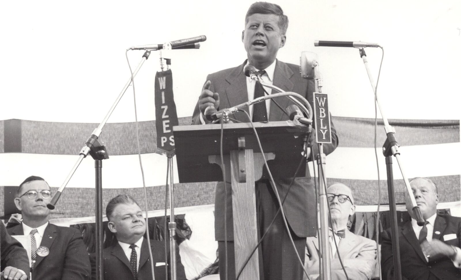 Sen. John F. Kennedy spoke to a crowd estimated at more than 7,500 on Oct. 17, 1960, at Wittenberg Stadium. Behind him, from left, are County Commissioner Jack Hamilton, E.G. Patmos, then president of Springfieldâs City Commission Wittenberg University President Clarence Stoughton and Ohio Gov. Michael V. DiSalle. DAYTON DAILY NEWS ARCHIVE