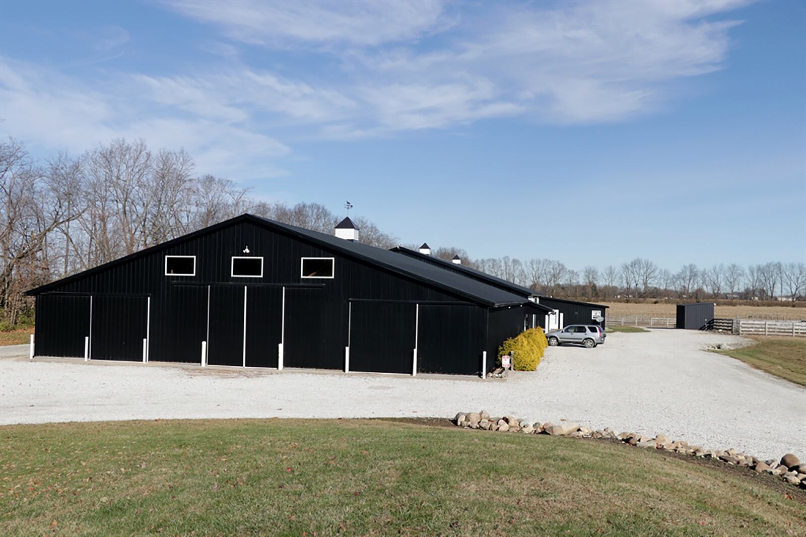 The Miami County property includes a custom barn that has a 75-foot-by-100-foot indoor equestrian area with bar-like viewing area. The barn has 21 matted stalls, grooming and wash stalls, a large tack room, restroom, office and a storage area for hay and equipment with separate sliding barn doors. CONTRIBUTED PHOTO BY KATHY TYLER