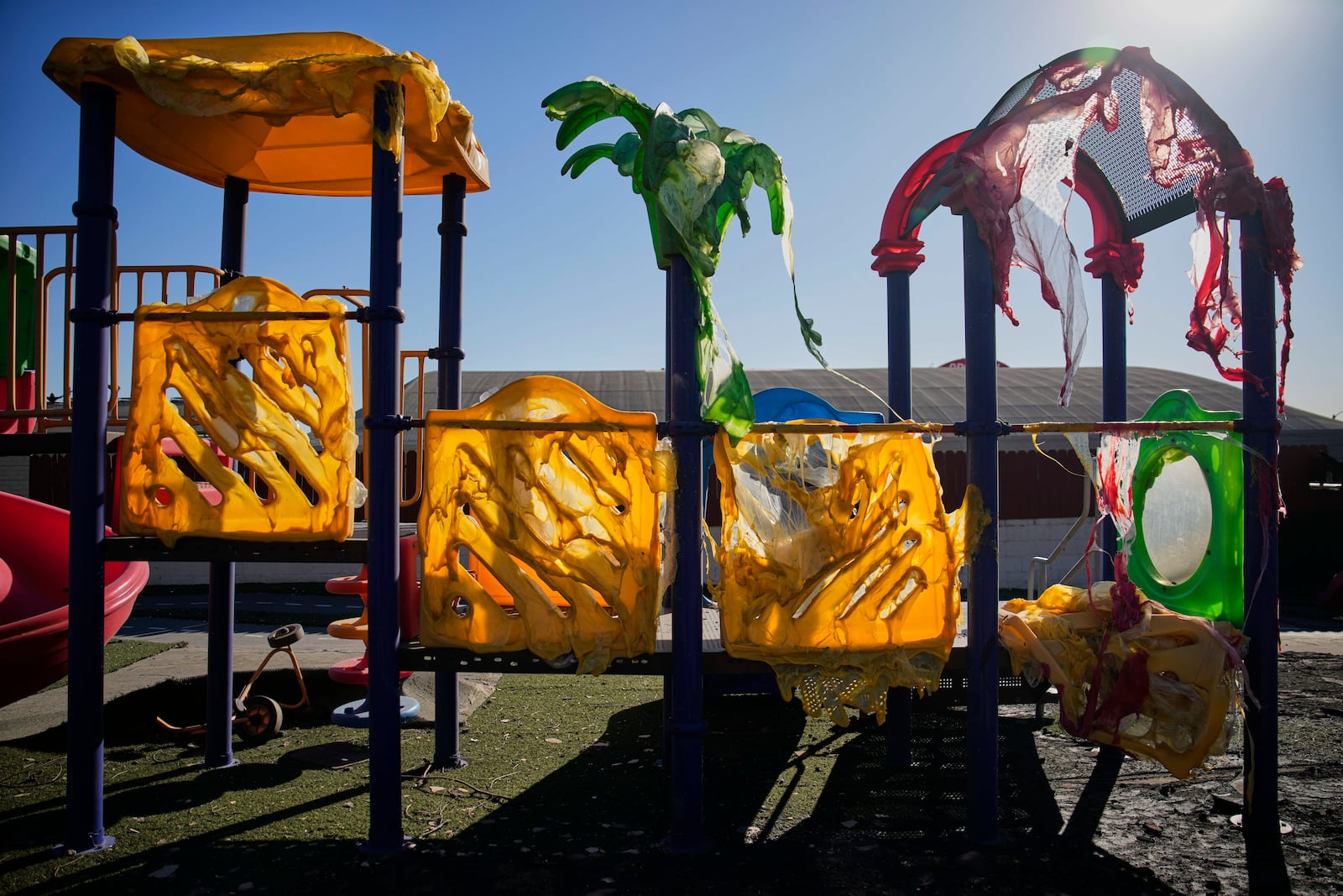 A jungle gym melted and destroyed by the Eaton Fire is seen at a school, Wednesday, Jan. 15, 2025, in Altadena, Calif. (AP Photo/John Locher)