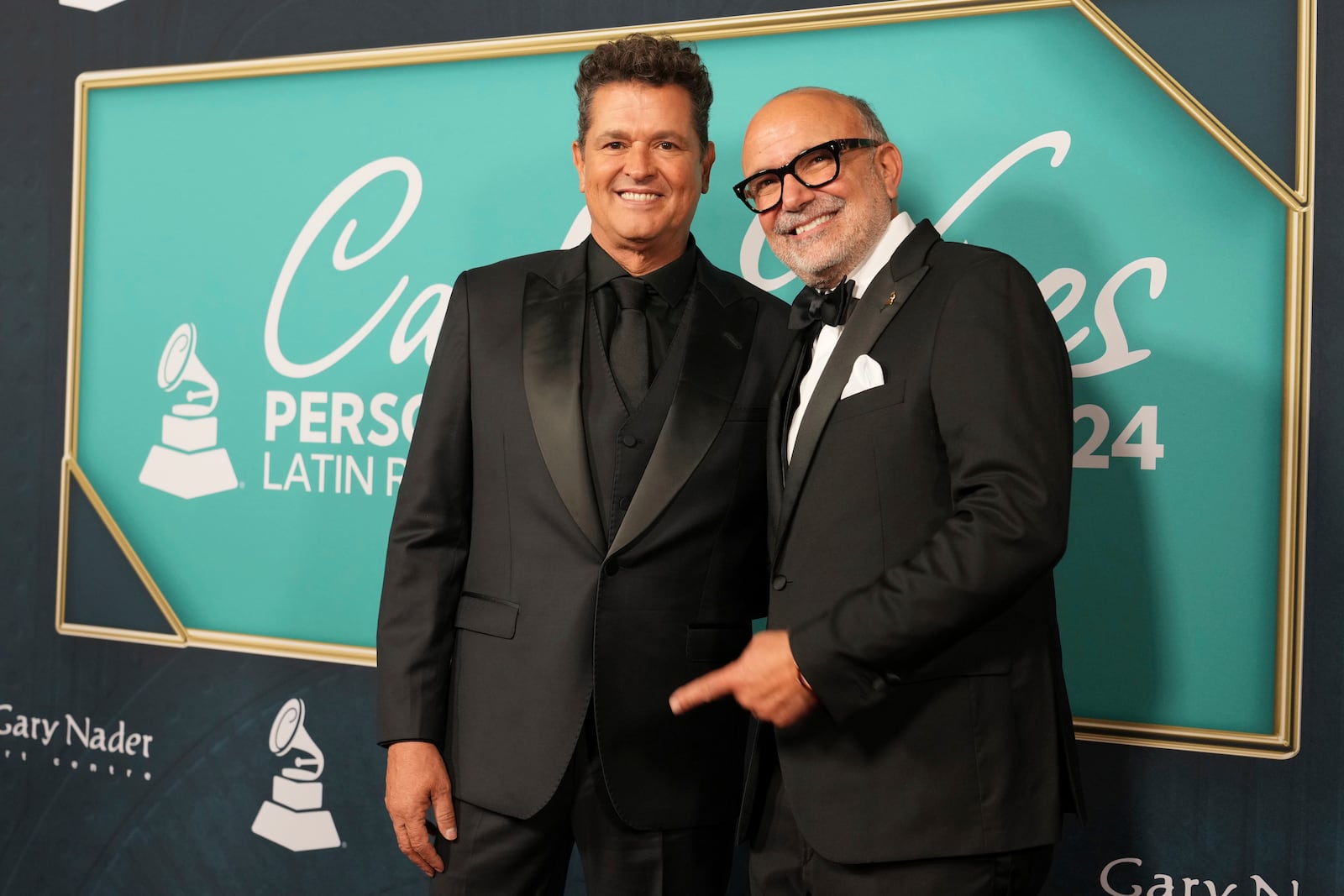 Carlos Vives, the Latin Grammys Person of the Year, poses with CEO Manuel Abud, Wednesday, Nov. 13, 2024, in Miami Beach, Fla. (AP Photo/Lynne Sladky)