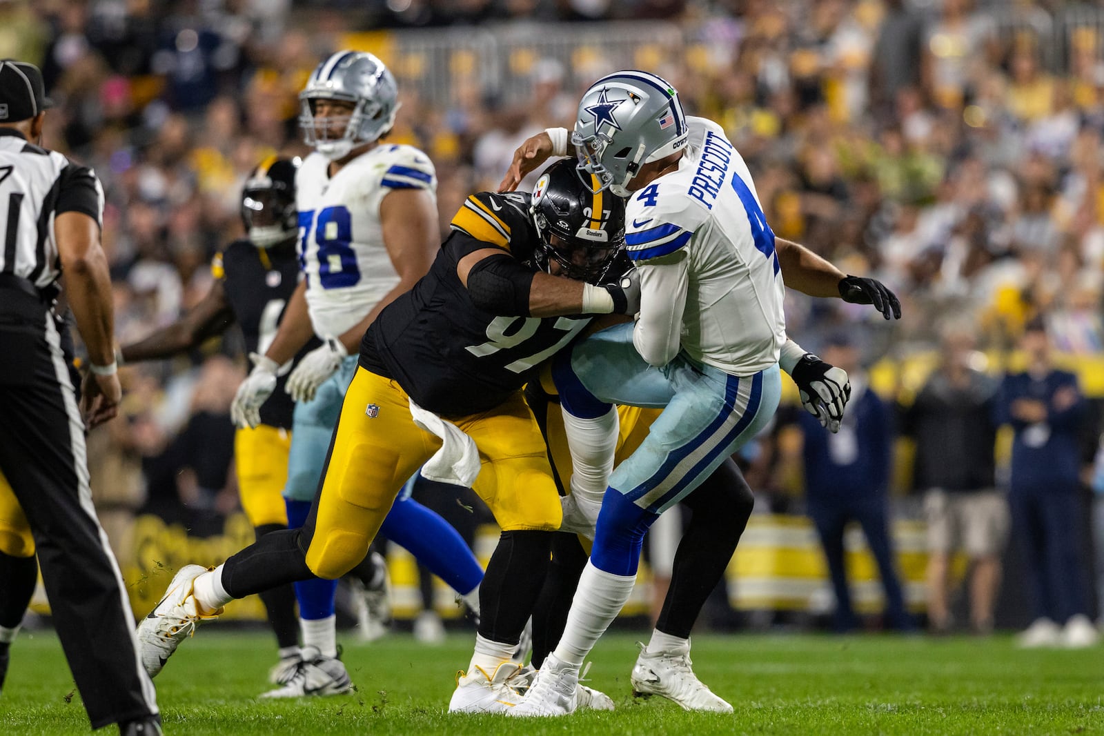 Pittsburgh Steelers defensive tackle Cameron Heyward (97) hits Dallas Cowboys quarterback Dak Prescott (4) while throwing during an NFL football game, Sunday, Oct. 6, 2024, in Pittsburgh. (AP Photo/Matt Durisko)