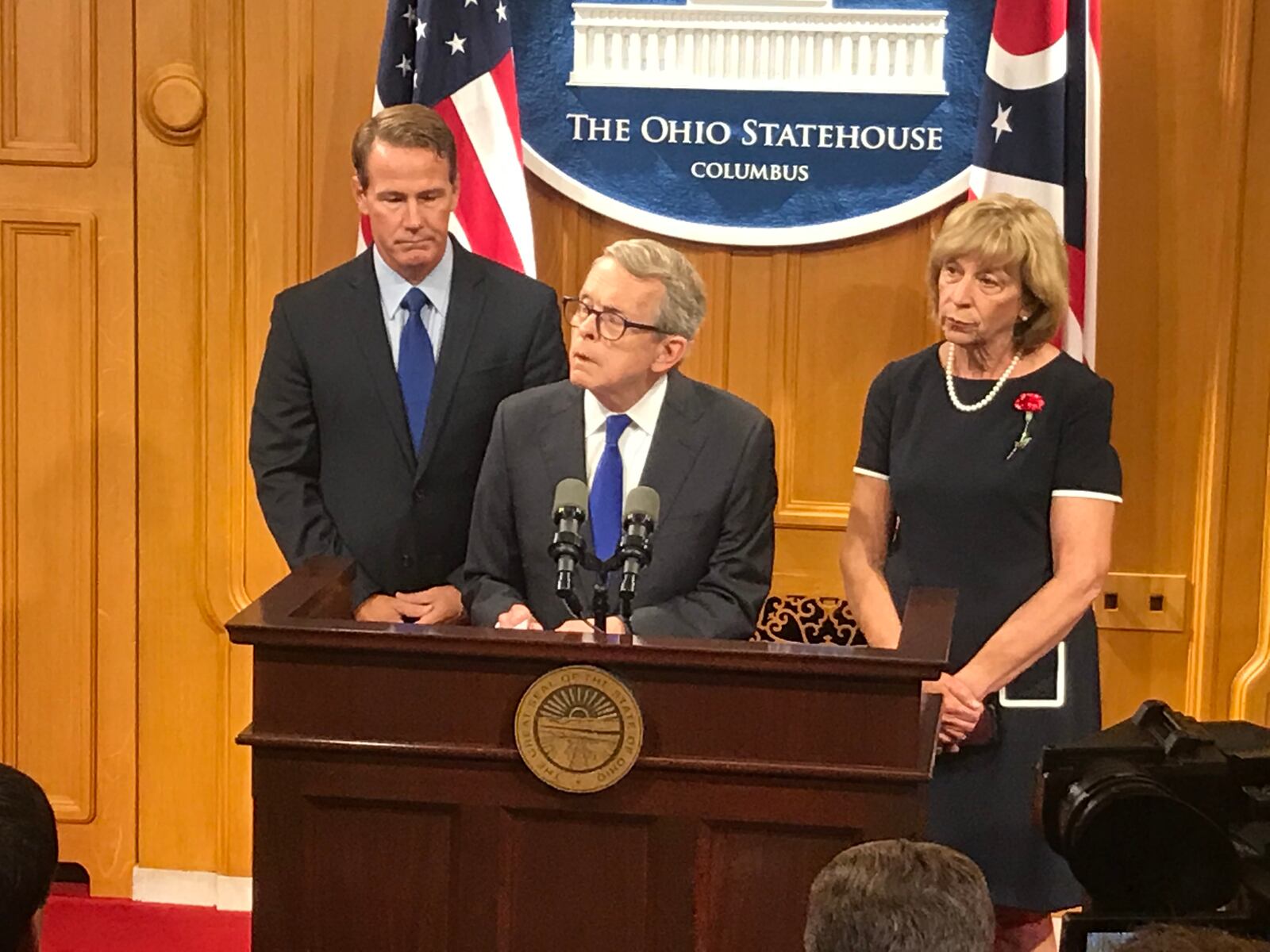 Ohio Gov. Mike DeWine asked lawmakers Tuesday to act on red-flag laws, background checks, and tougher penalties for violent felons to deal with gun violence and mental health in the wake of Sunday’s mass shooting in Dayton. He's shown with Lt. Gov. Jon Husted and wife, Fran DeWine. JIM OTTE/STAFF