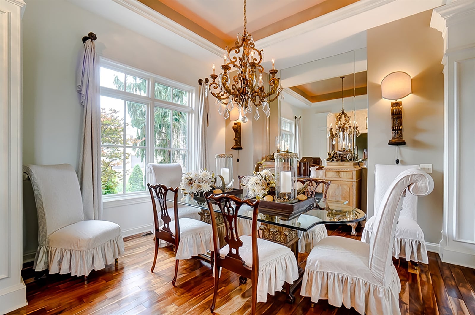 Columns with woodwork details offset the formal dining room from the open foyer. The dining room has a tray ceiling with chandelier and a built-in niche for a sideboard. CONTRIBUTED PHOTO