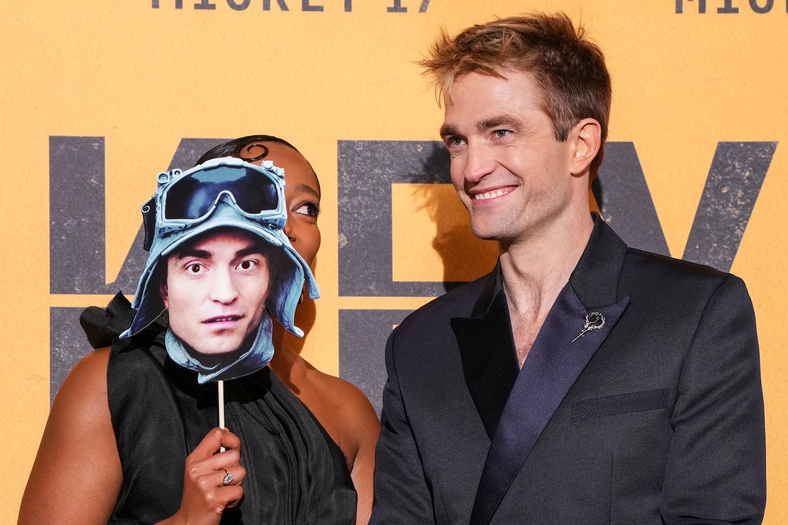 Naomi Ackie, left, and Robert Pattinson pose for photographers upon arrival at the World premiere for the film 'Mickey 17' on Thursday, Feb. 13, 2025, in London. (Photo by Scott A Garfitt/Invision/AP)