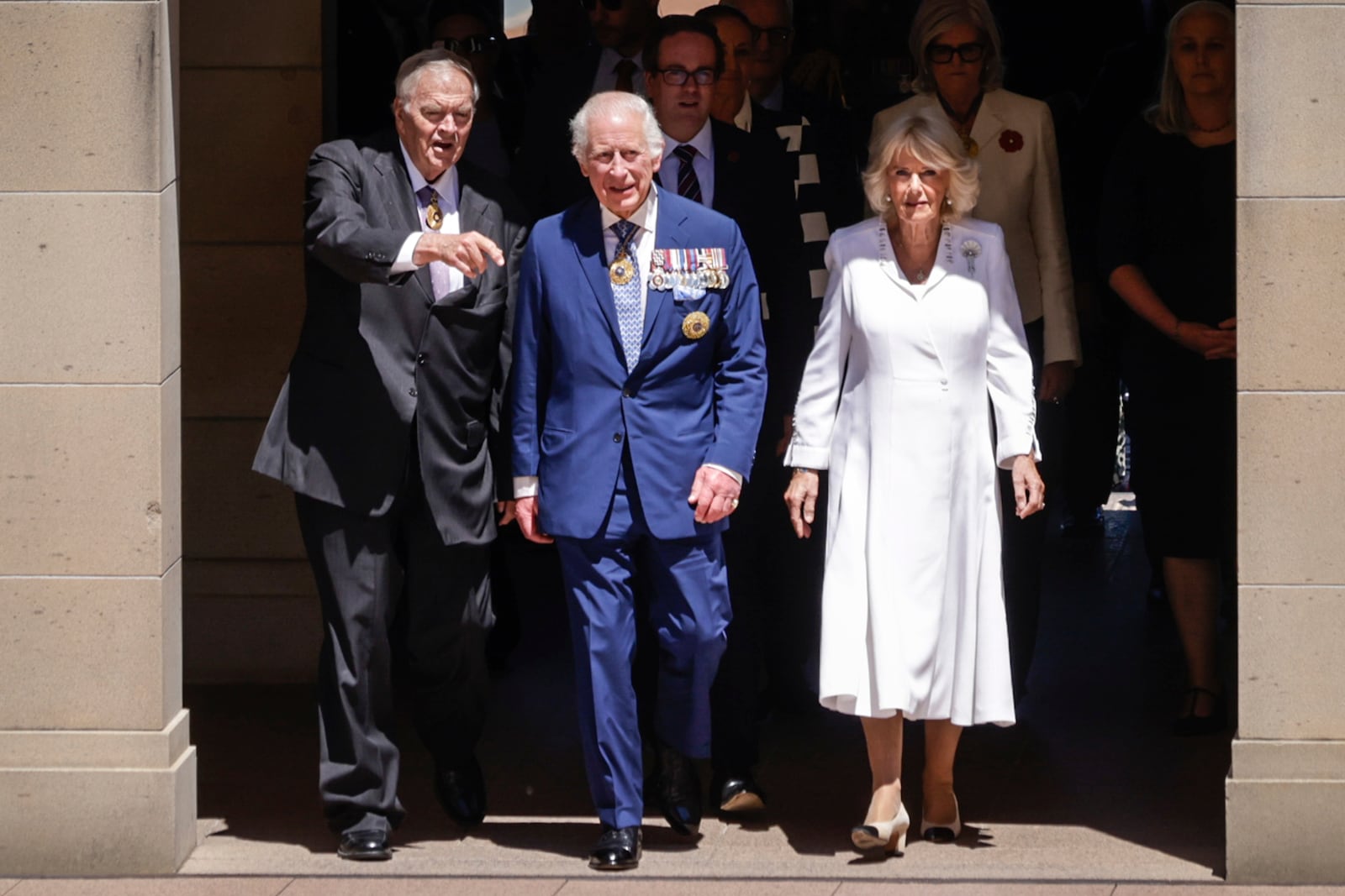 King Charles III and Queen Camilla arrive at the Australian War Memorial accompanied by Australian War Memorial Council Chair Kim Beazley Canberra, left, in Canberra , Australia, Monday, Oct. 21, 2024. (Brook Mitchell/ Pool Photo via AP)