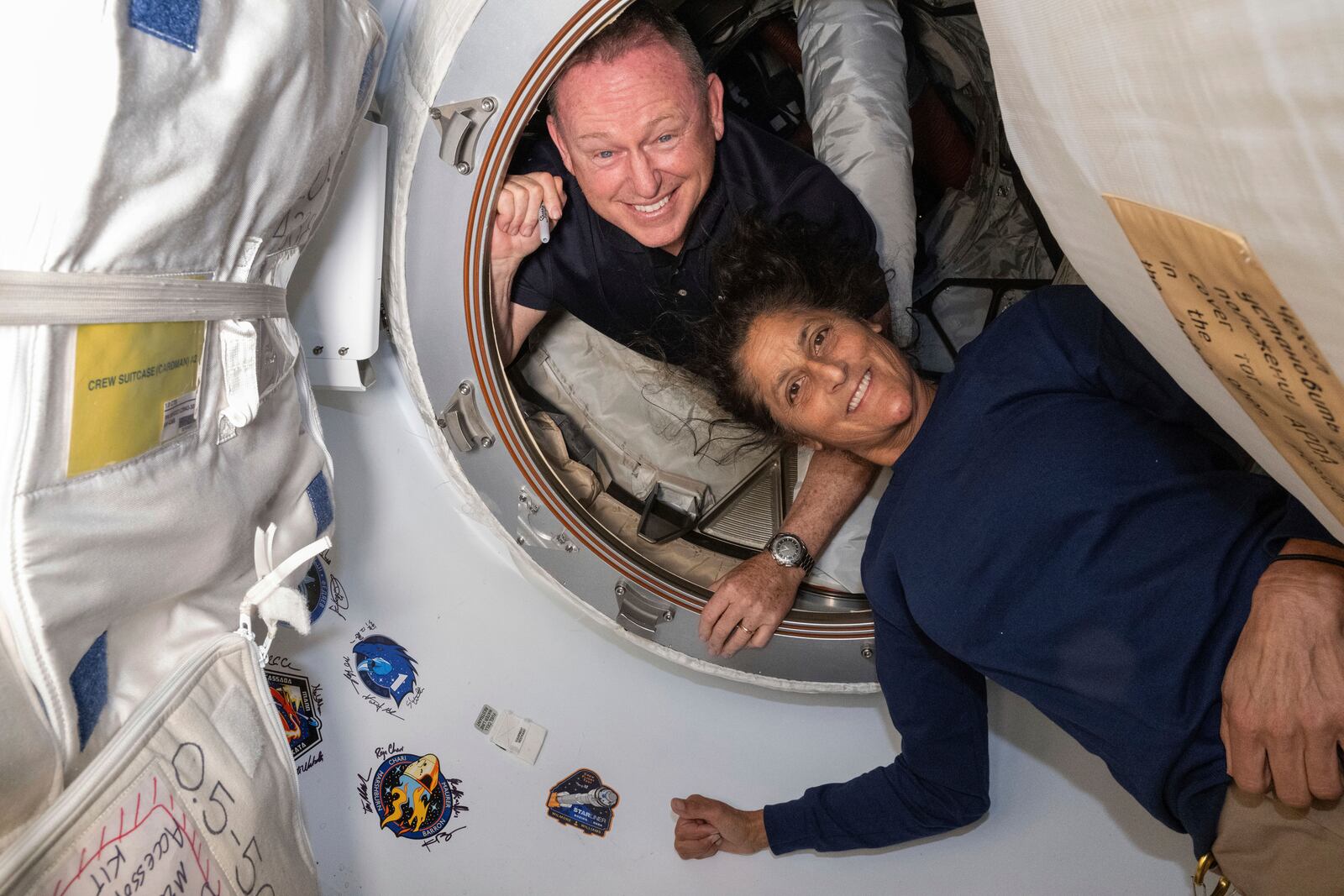 FILE - In this photo provided by NASA, Boeing Crew Flight Test astronauts Butch Wilmore, left, and Suni Williams pose for a portrait inside the vestibule between the forward port on the International Space Station's Harmony module and Boeing's Starliner spacecraft on June 13, 2024. (NASA via AP, File)