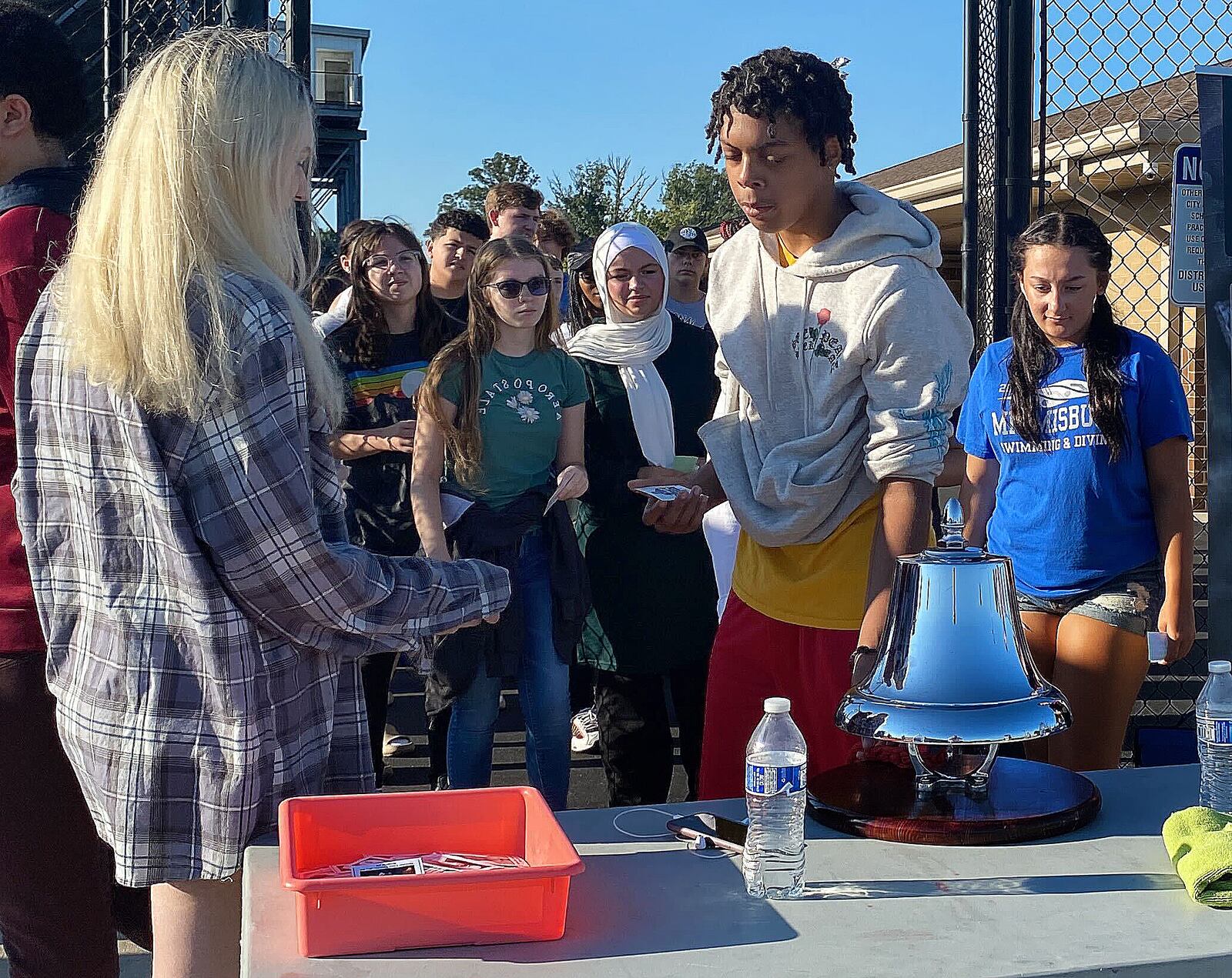 Miamisburg High School student Jacobi Jackson, a freshman, rings a bell after reading aloud the name of FDNY Battalion Chief Orio Palmer at the end of the school's second annual 9/11 Stair Climb on Friday, Sept. 9, 2022. The event was organized by Siobhan Tirado, an MHS intervention specialist with a focus on history, and social studies teacher Katie Lay. ERIC SCHWARTZBERG/STAFF