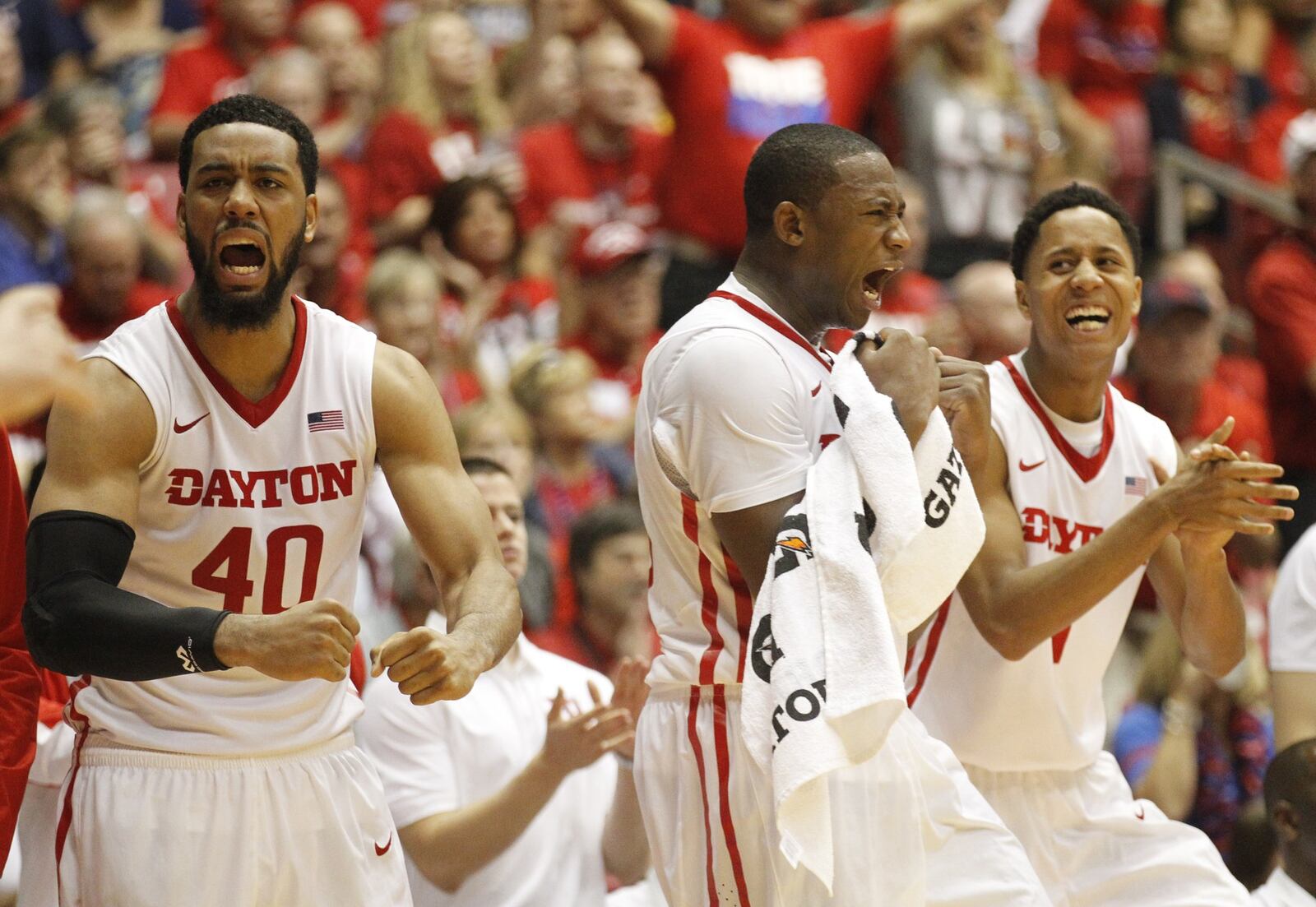 Dayton’s Devon Scott, left, Kendall Pollard and Darrell Davis celebrate a basket against Texas A&M in the first round of the Puerto Rico Tip-Off on Thursday, Nov. 20, 2014, at Coliseo Roberto Clemente in San Juan, P.R. David Jablonski/Staff