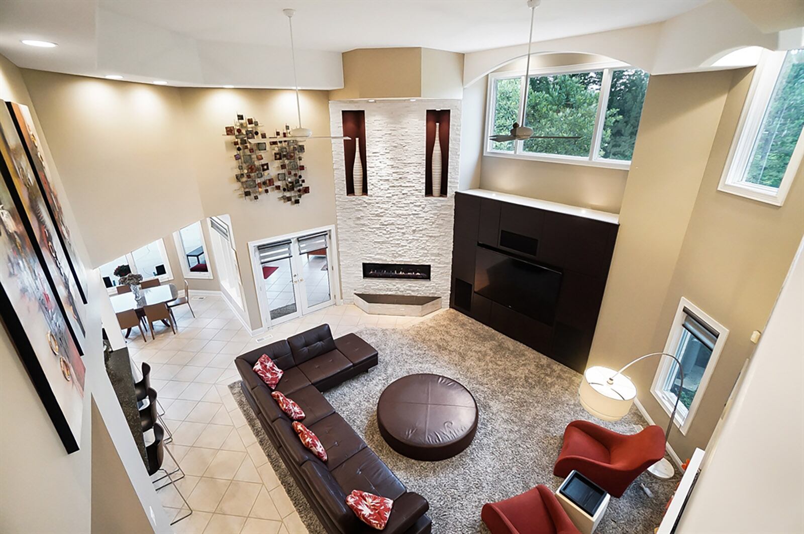 A two-story ceiling allows for the stone gas fireplace to accent the circular family room. The rectangular fireplace has 2 built-in artwork nooks and a raised hearth. CONTRIBUTED PHOTO