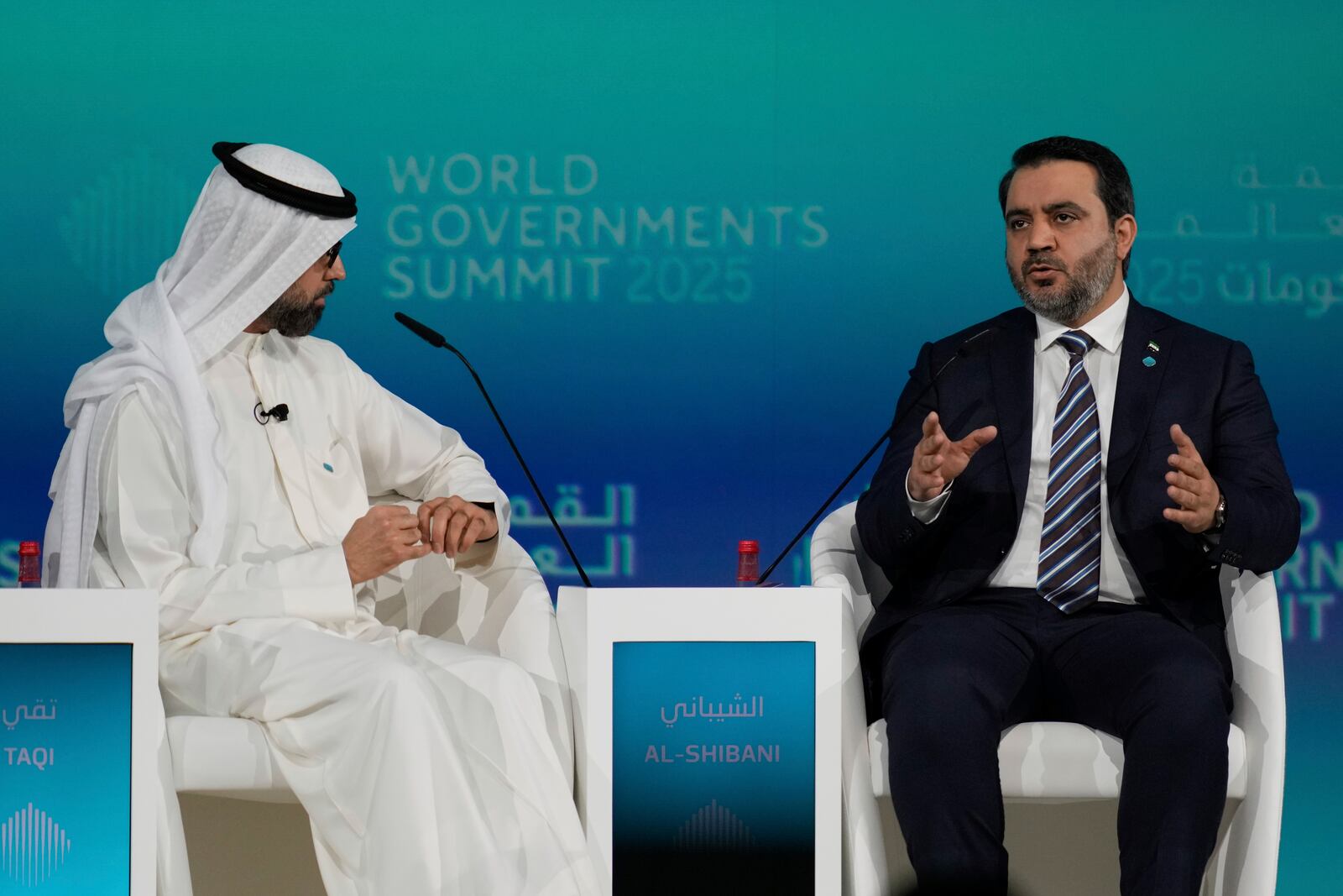 Syria's Interim Foreign Minister Asaad al-Shibani, right, talks to Kuwaiti journalist Ammar Taqi during the World Governments Summit in Dubai, United Arab Emirates, Wednesday, Feb. 12, 2025. (AP Photo/Altaf Qadri)