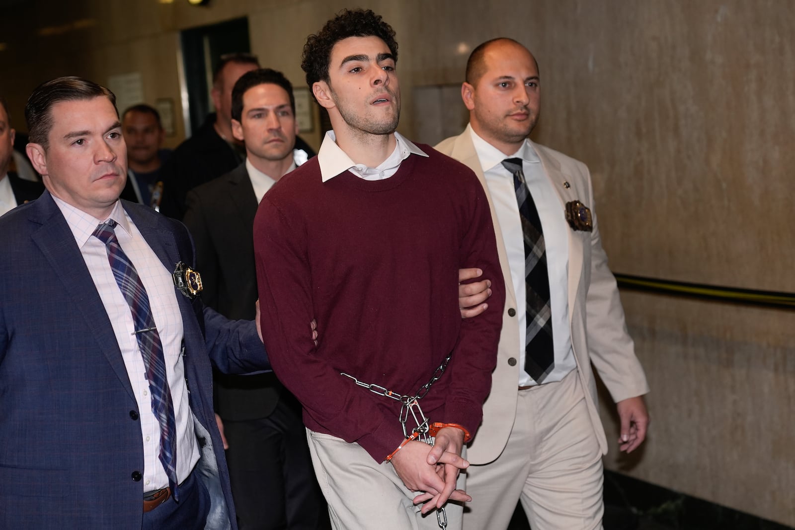 Luigie Mangione is escorted into Manhattan Criminal court for his arraignment in the killing of UnitedHealthcare CEO Brian Thompson, Monday, Dec. 23, 2024, in New York. (AP Photo/Seth Wenig)