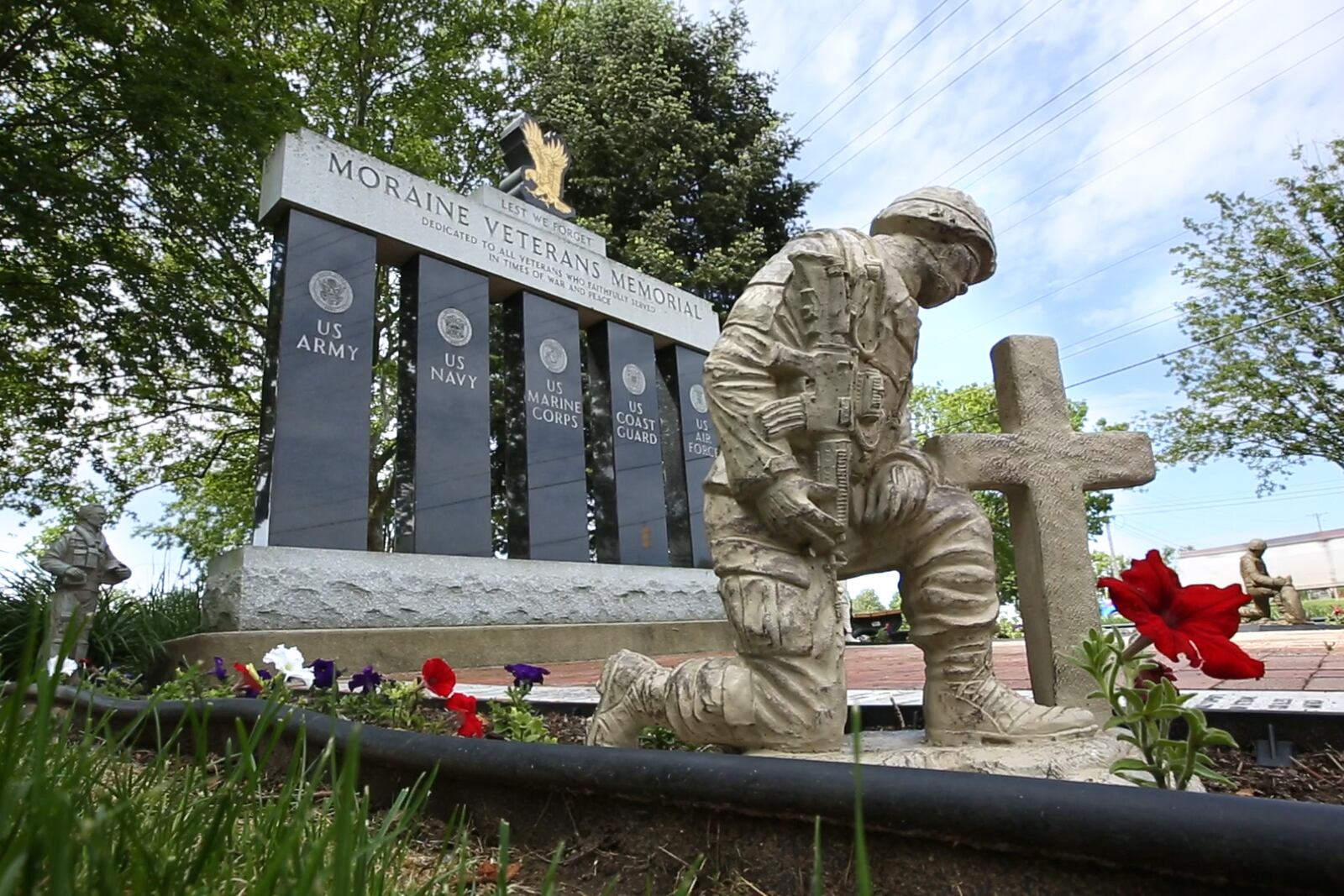 The Moraine Veterans Memorial is located in front of the Moraine Municipal Building.  The monument a memorial brick walkway, flowers and statuettes of modern soldiers.   TY GREENLEES / STAFF