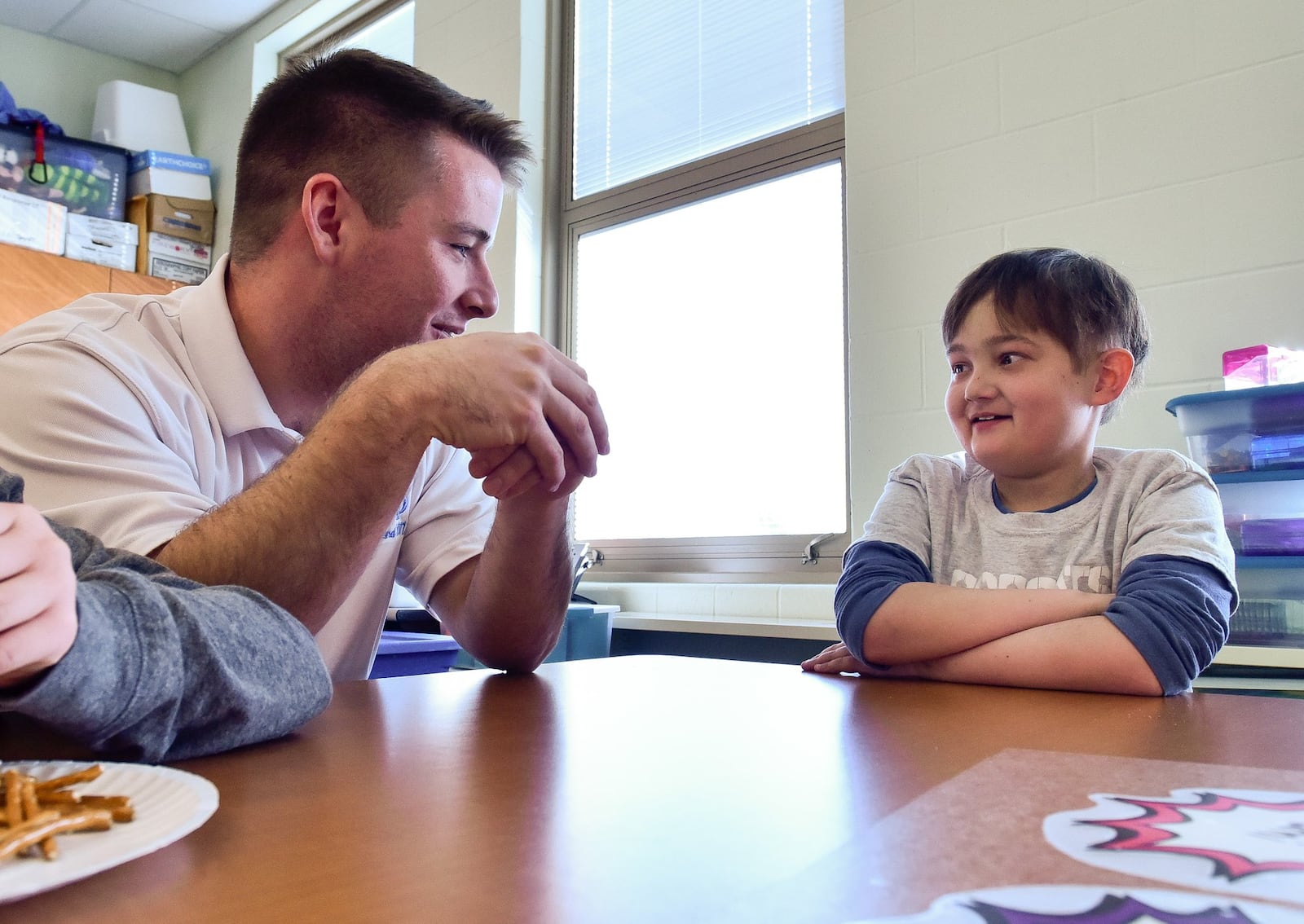 Sean McKeon, left, a Miami University senior majoring in finance and accounting, spends his Friday afternoon, Dec. 7 with third grader Noah Trumball, 10, at Bridgeport Elementary School in Hamilton. McKeon and other members of the Pi Kappa Phi fraternity he is in volunteer with special needs students at the school and he has developed a special relationship with Trumball. NICK GRAHAM/STAFF