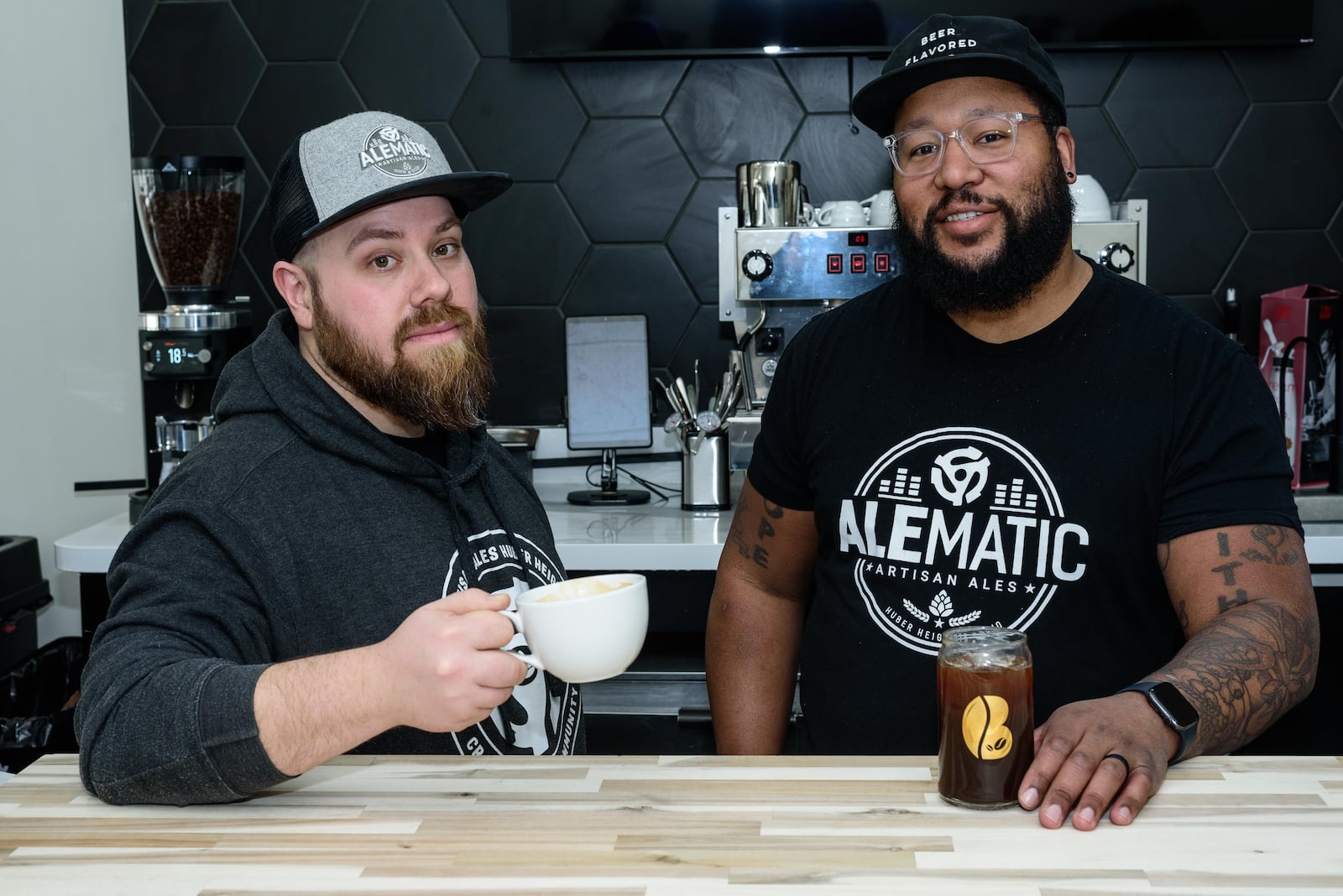 From left to right: Owners Mike Meholick and Jerrod Fisher of the new B-Side Coffee Bar, located at 6178 Chambersburg Rd. in Huber Heights. Meholick, Fisher and Greg Cason (not pictured) are also the owners of Alematic Artisan Ales next door. TOM GILLIAM / CONTRIBUTING PHOTOGRAPHER