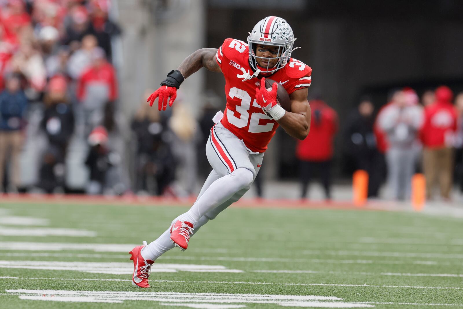 Ohio State running back TreVeyon Henderson runs the ball against Indiana during the first half of an NCAA college football game Saturday, Nov. 23, 2024, in Columbus, Ohio. (AP Photo/Jay LaPrete)